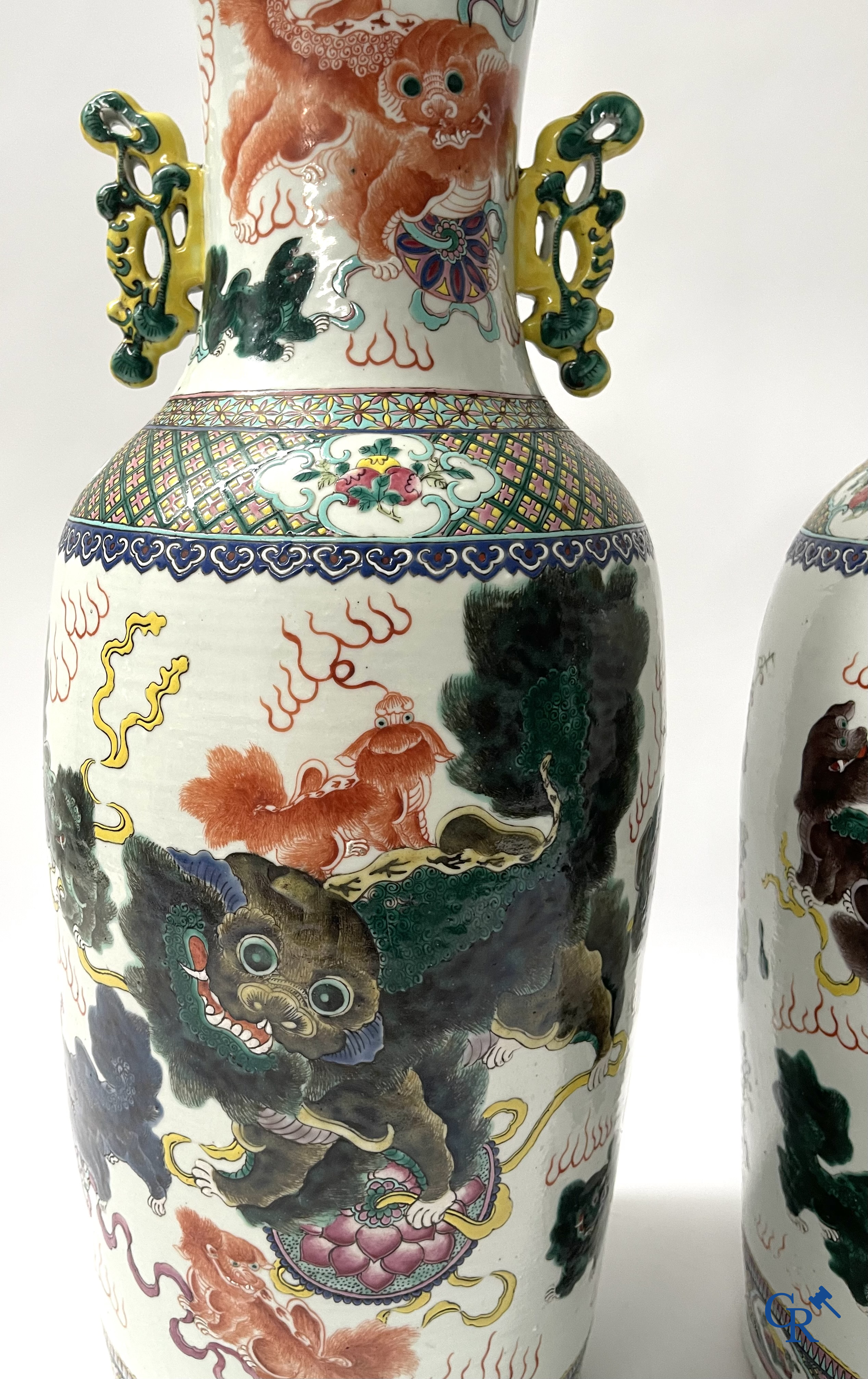 Asian Art, A pair of Chinese famille rose vases with peacocks and Fo dogs. 19th century.