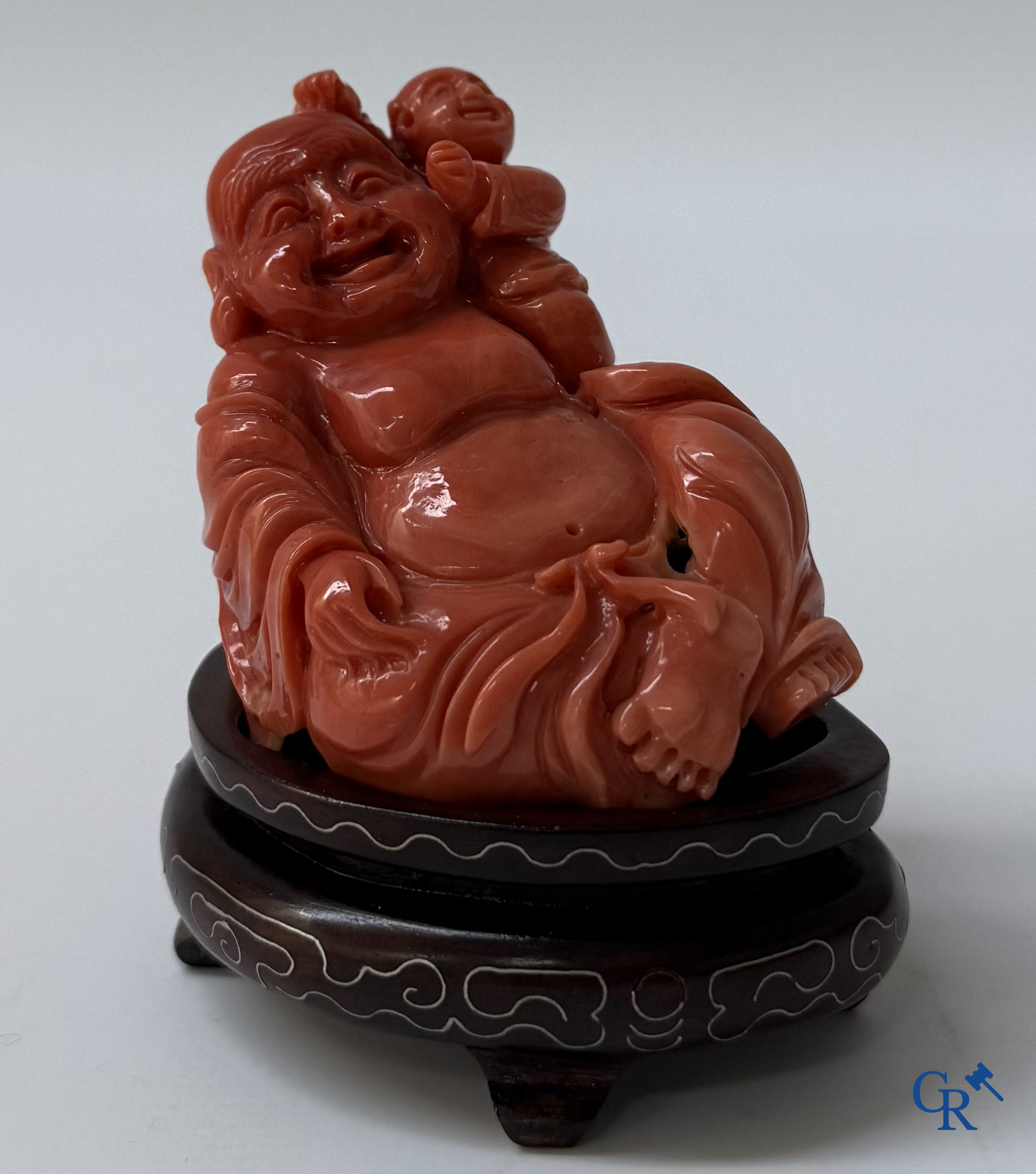 Asian Art, a Chinese carved red coral Buddha figure with child.