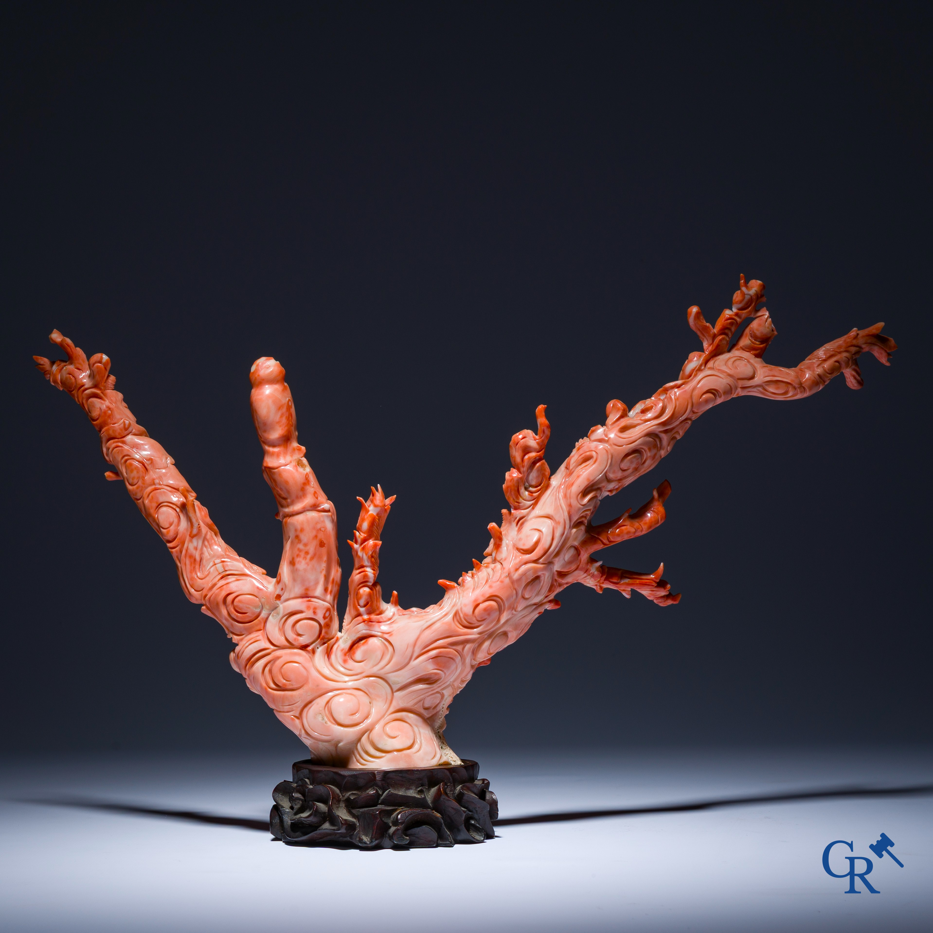 Asian Art, A Chinese group in finely carved red coral with ladies, dragons and children. 19th century.