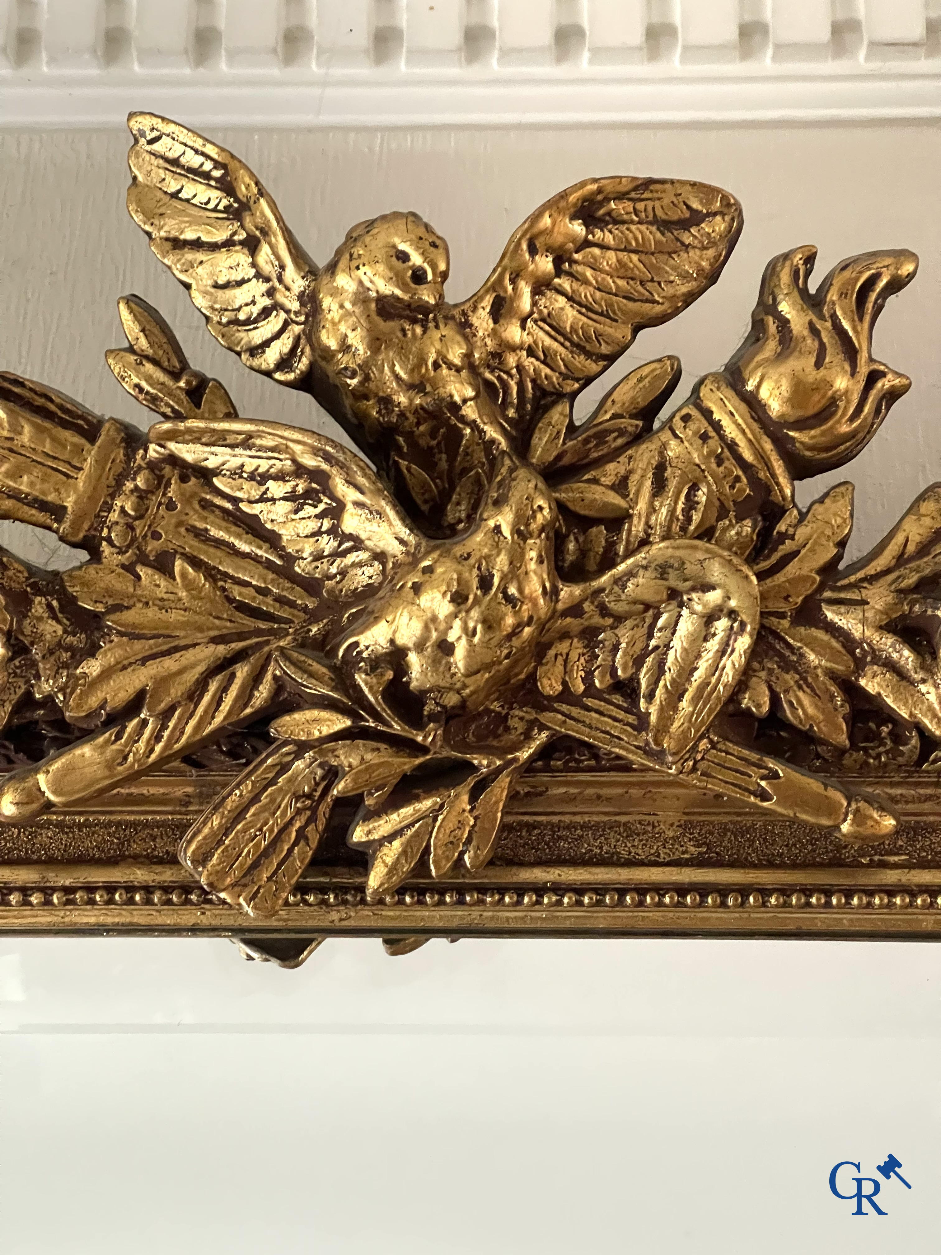 A large gilded fireplace mirror in LXVI style. Circa 1920.