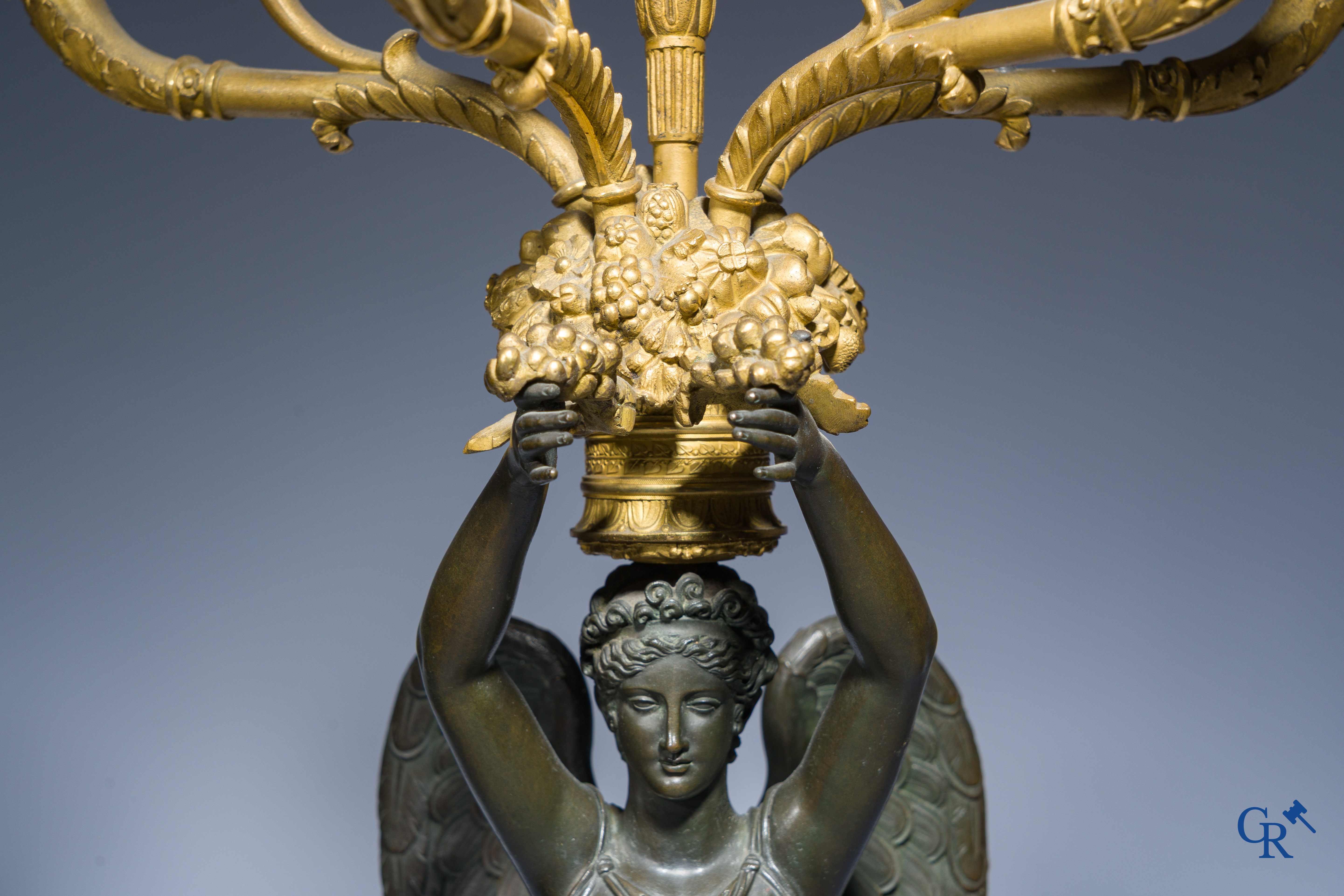 Empire, A pair of large gilded and patinated bronze candlesticks with winged women, circa 1810.