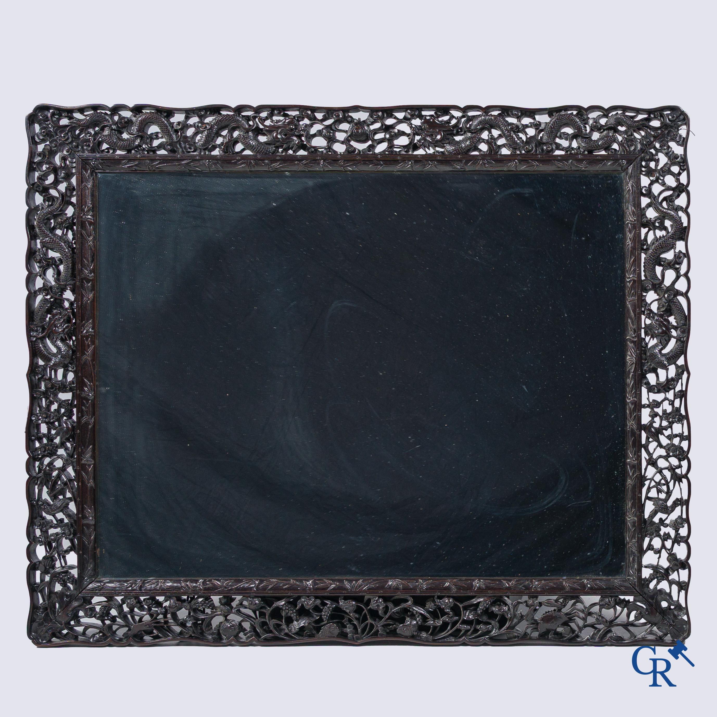 Asian Art, a large mirror in carved Chinese hardwood. 19th century.