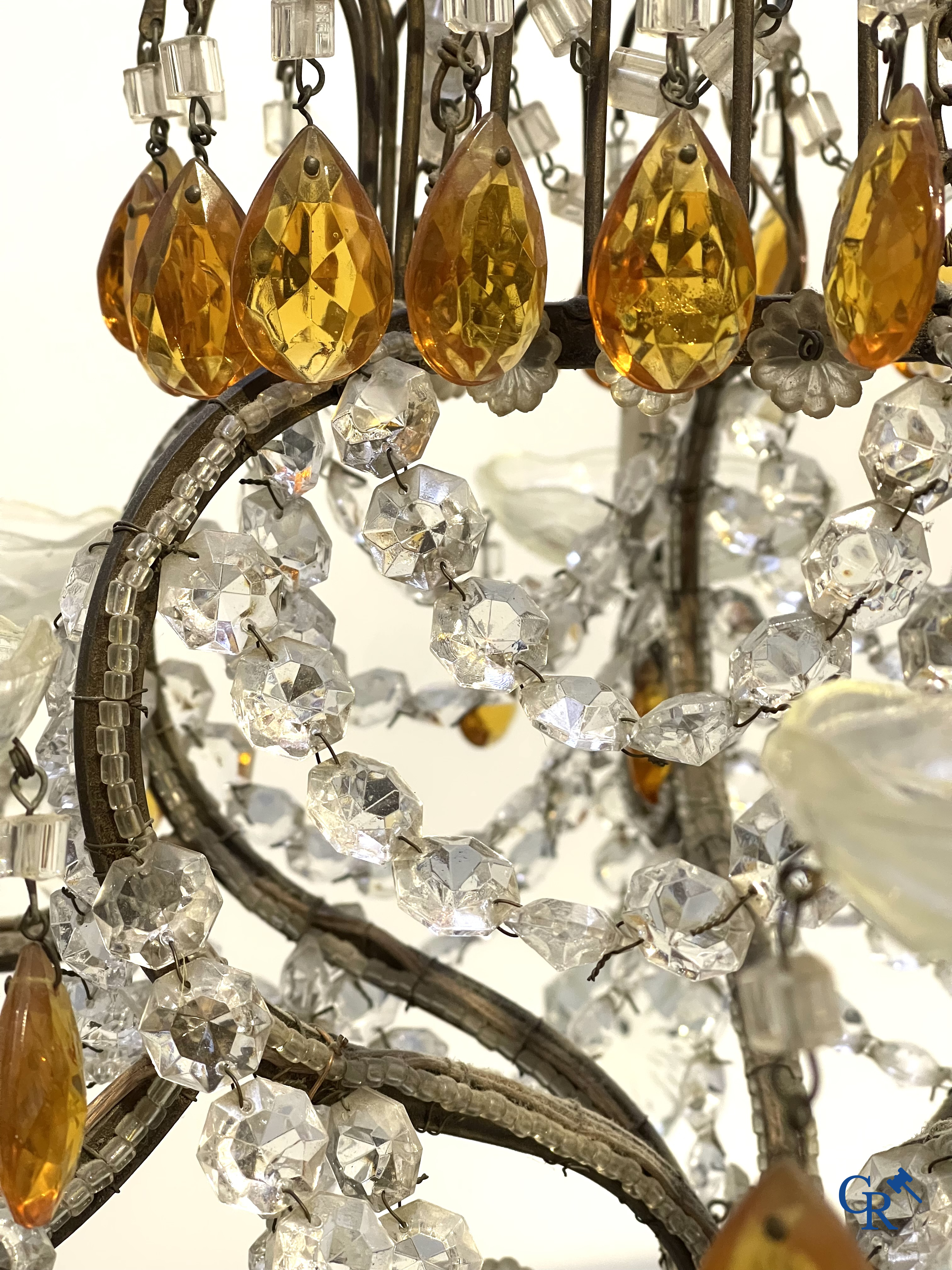 A large chandelier in crystal with double pearls on the frame.