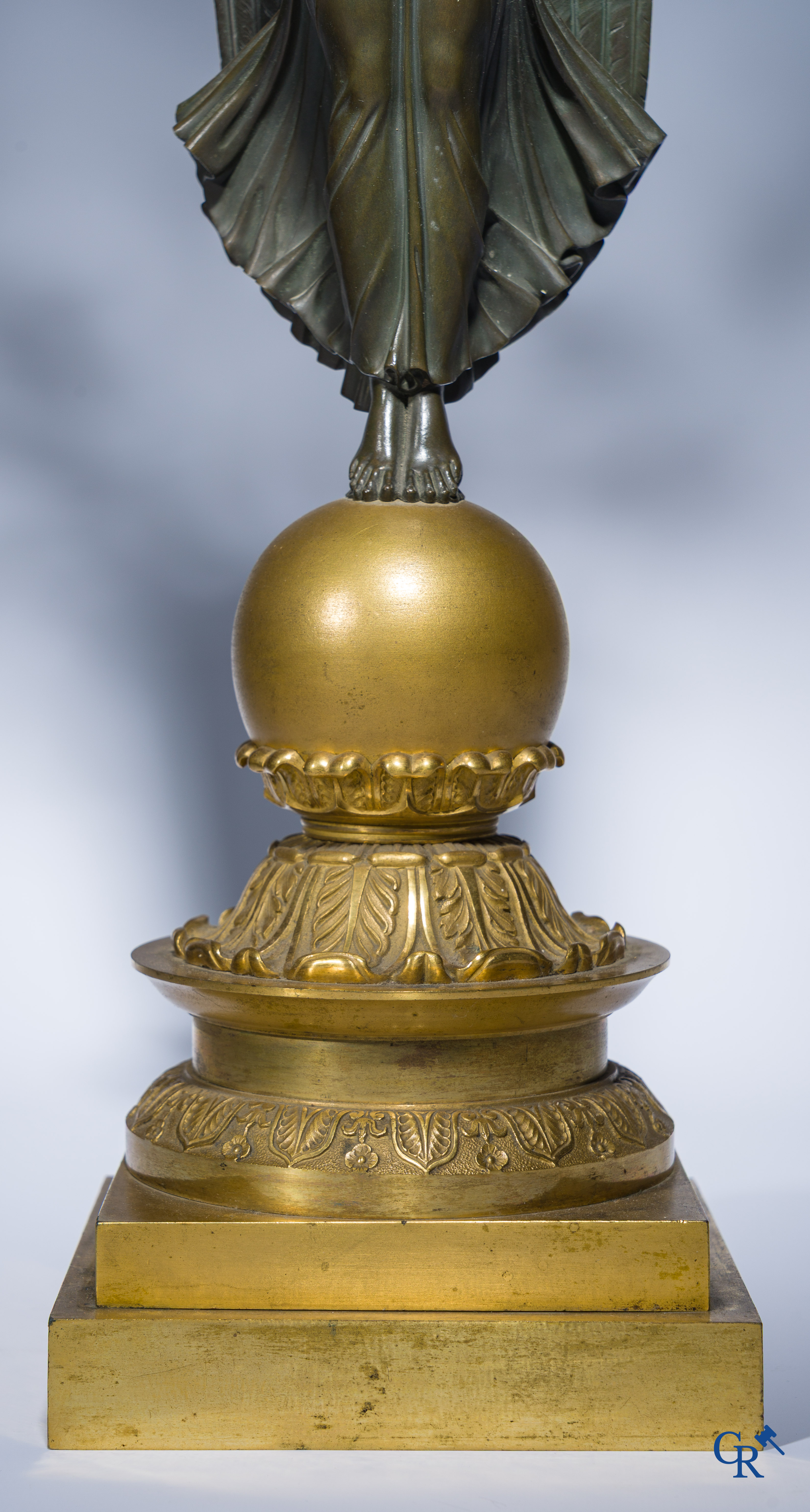 Empire, A pair of large gilded and patinated bronze candlesticks with winged women, circa 1810.