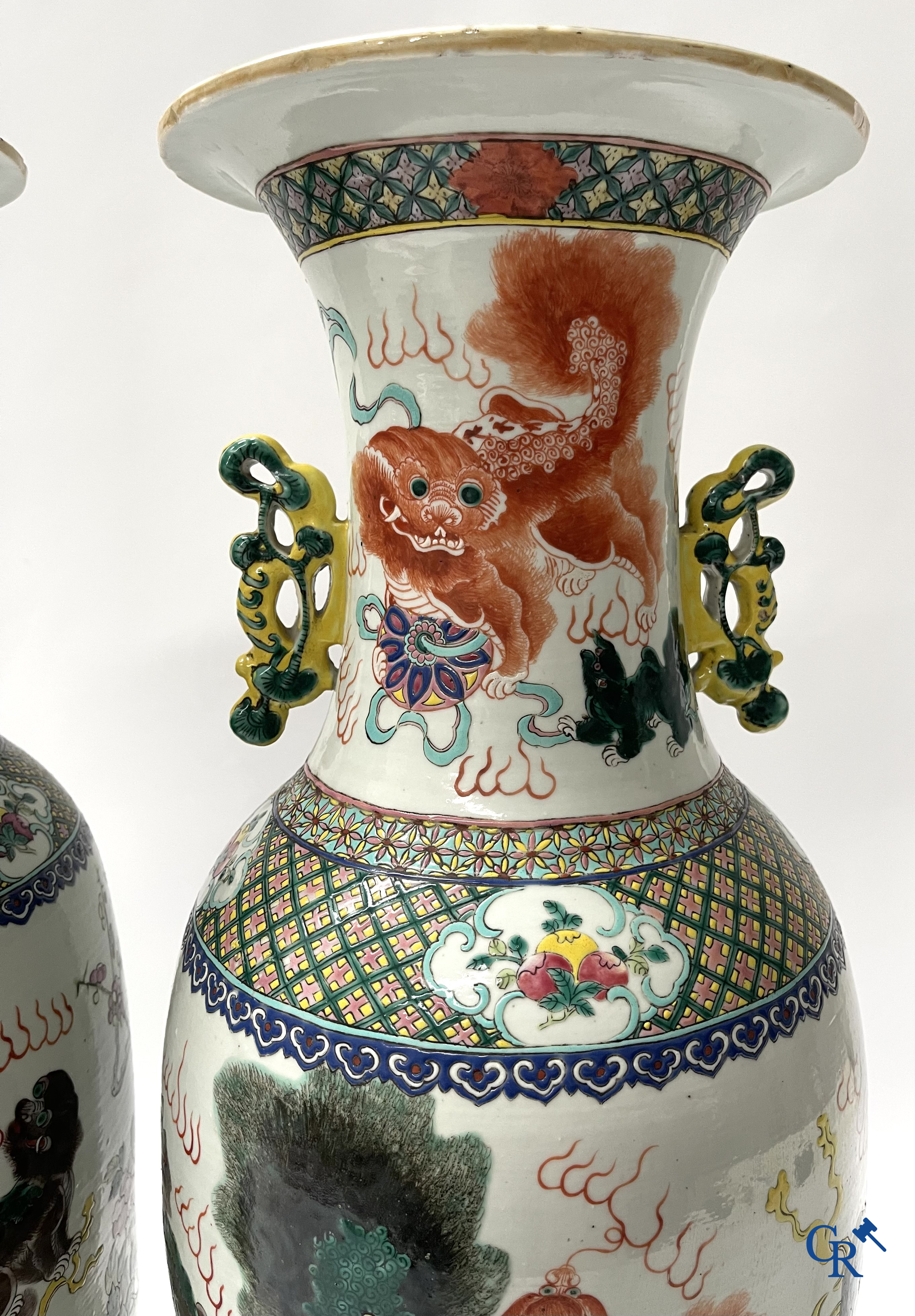 Asian Art, A pair of Chinese famille rose vases with peacocks and Fo dogs. 19th century.