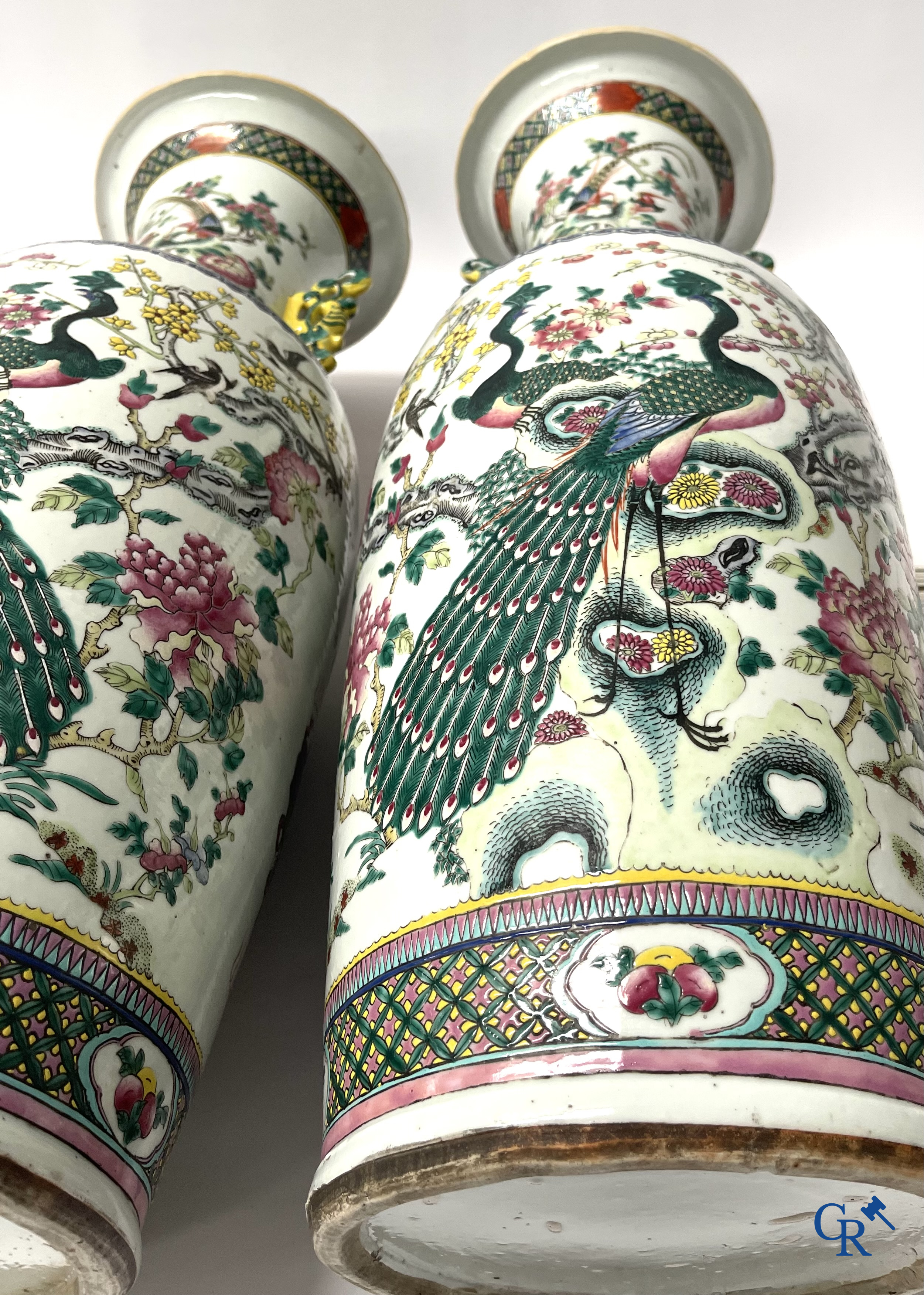 Asian Art, A pair of Chinese famille rose vases with peacocks and Fo dogs. 19th century.