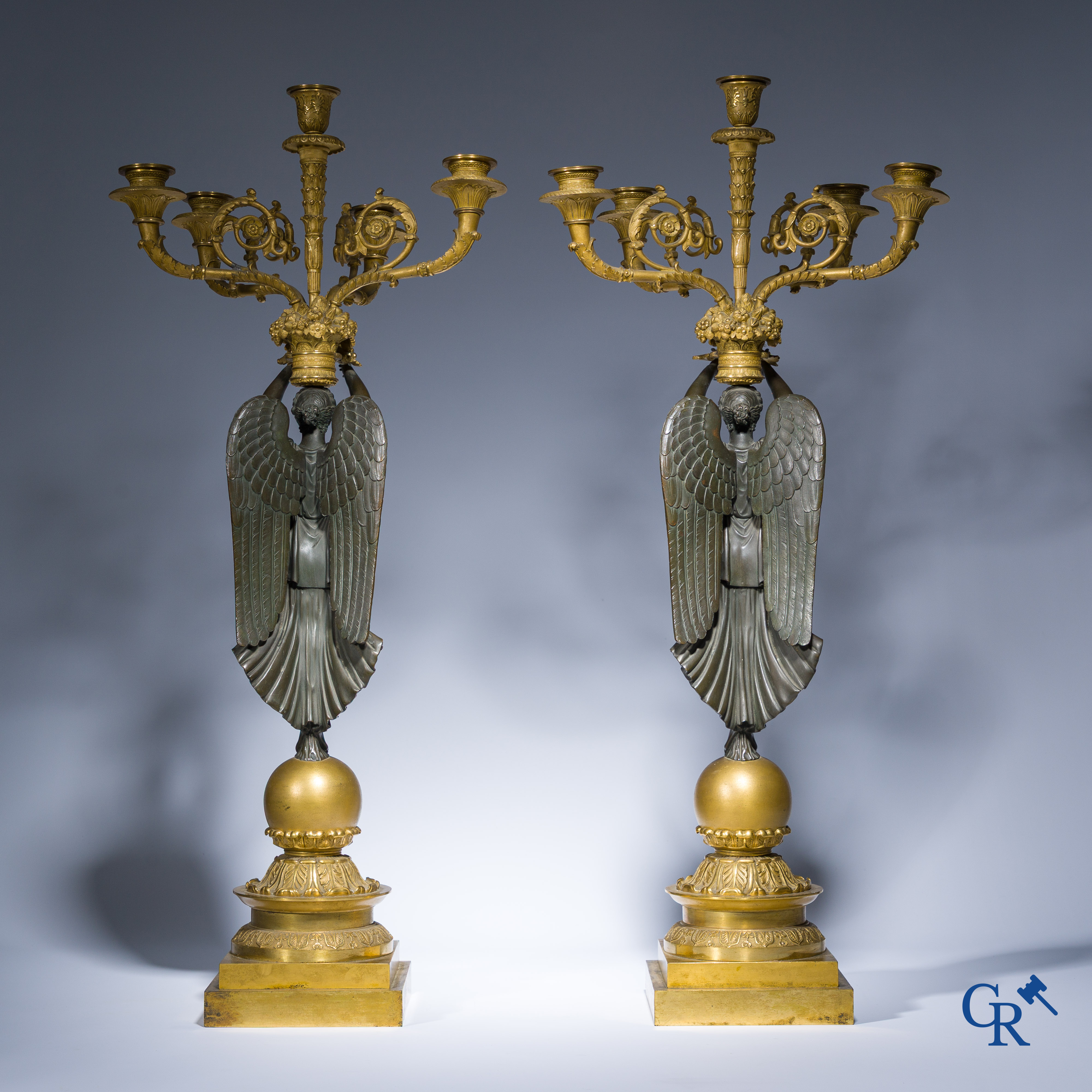 Empire, A pair of large gilded and patinated bronze candlesticks with winged women, circa 1810.