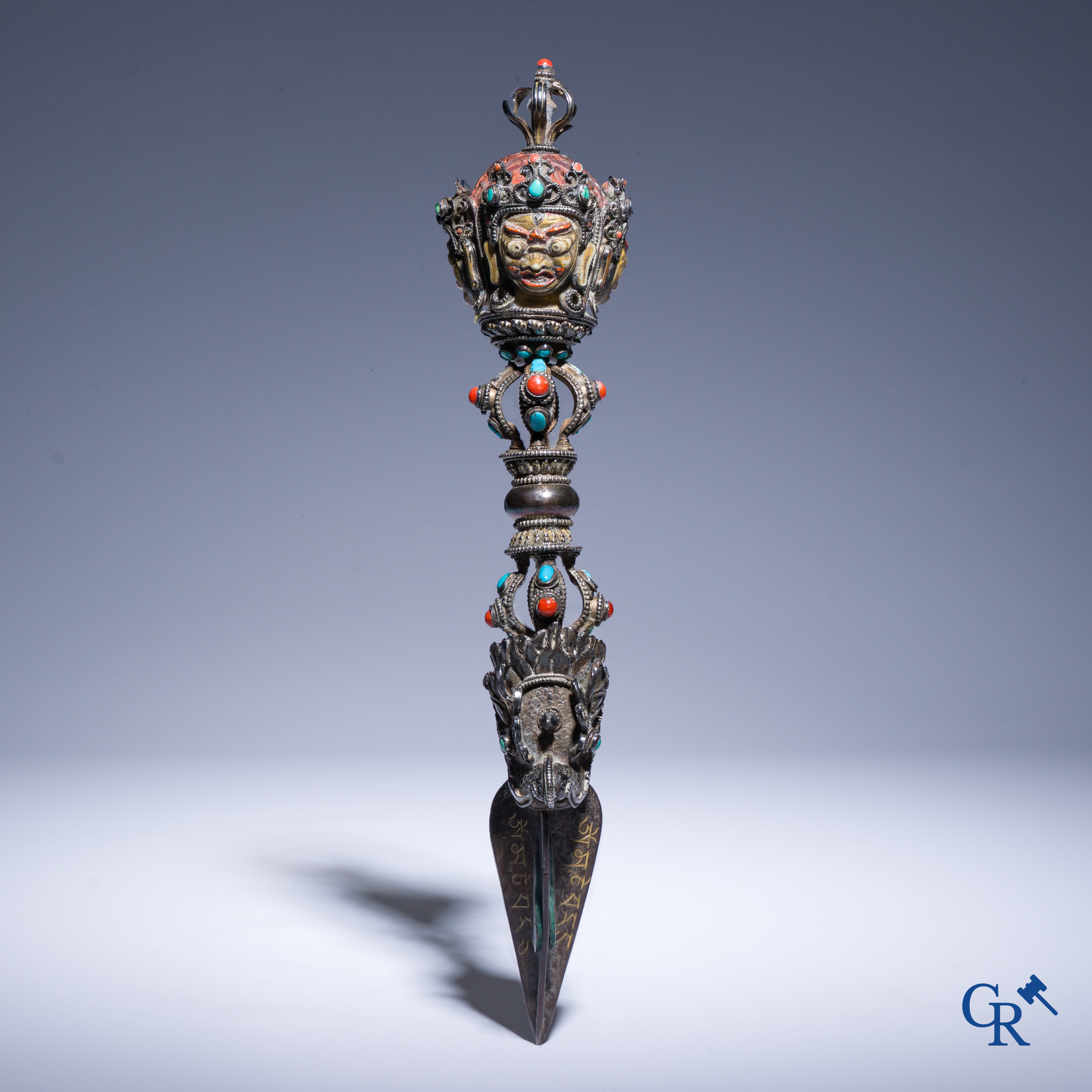 Asian Art, Phurba. Tibetan ritual dagger in silver, inlaid with turquoise and red coral.