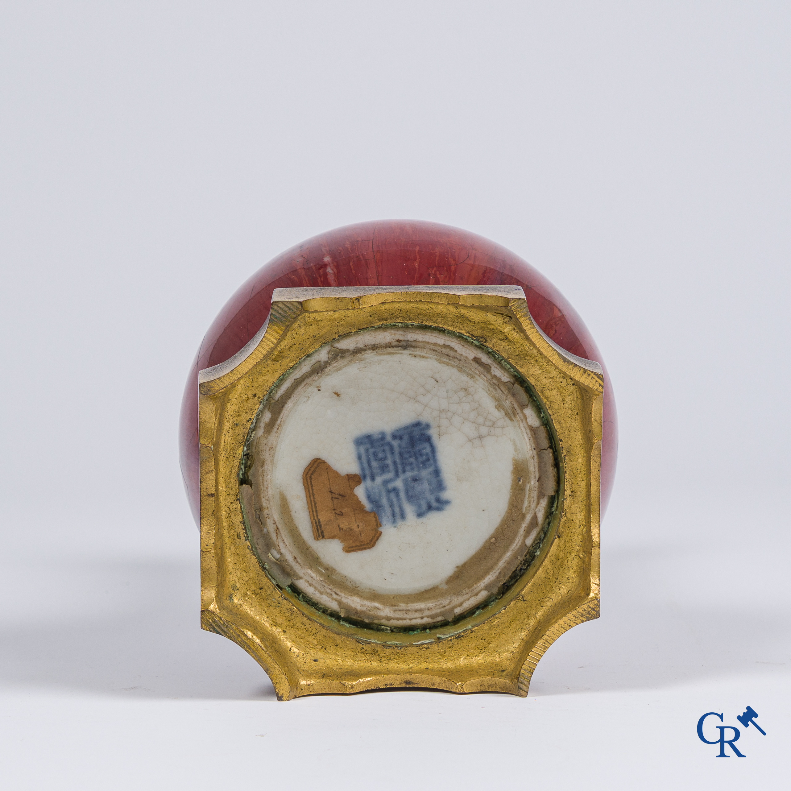 Asian Art, Chinese porcelain. A Chinese Sang de boeuf vase with gilded bronze. Marked.