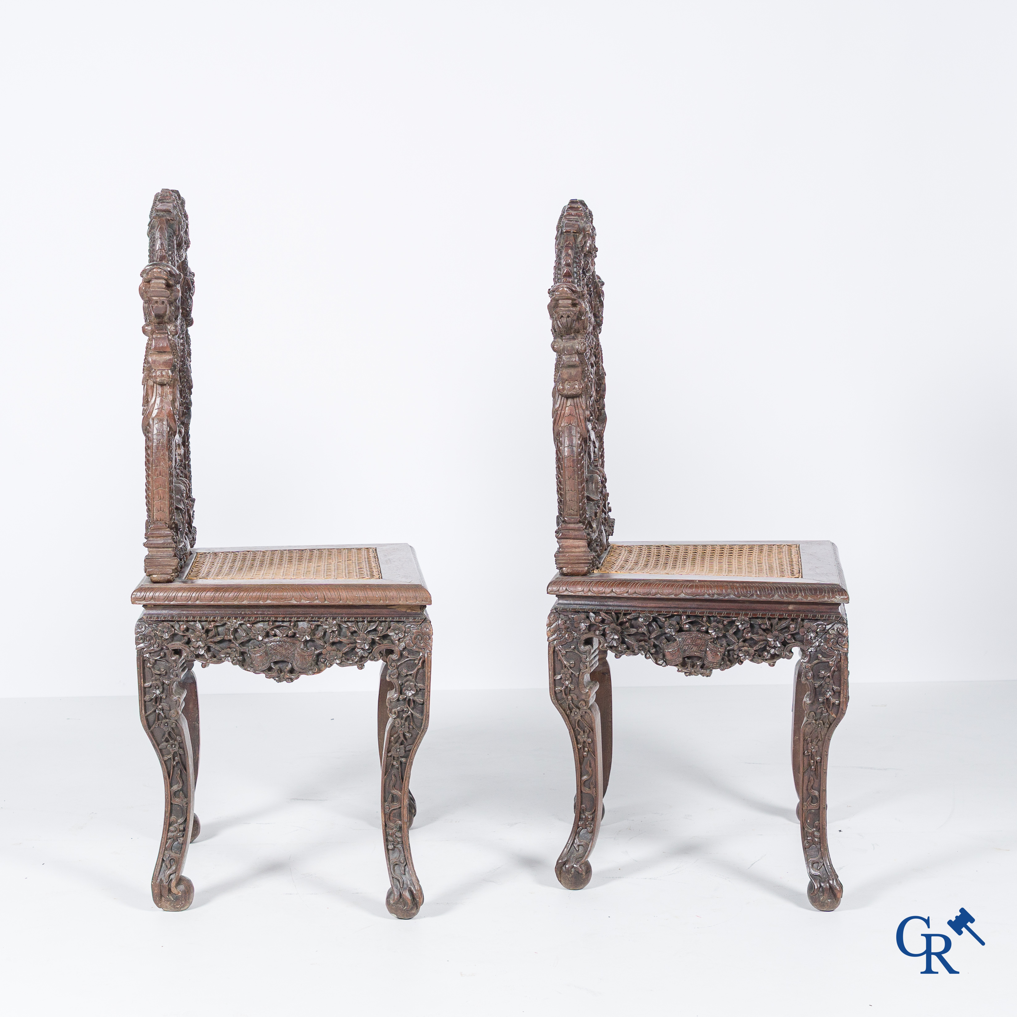 Asian Art, A pair of richly carved chairs with bats, dragons and flowers in Chinese hardwood. 19th century.