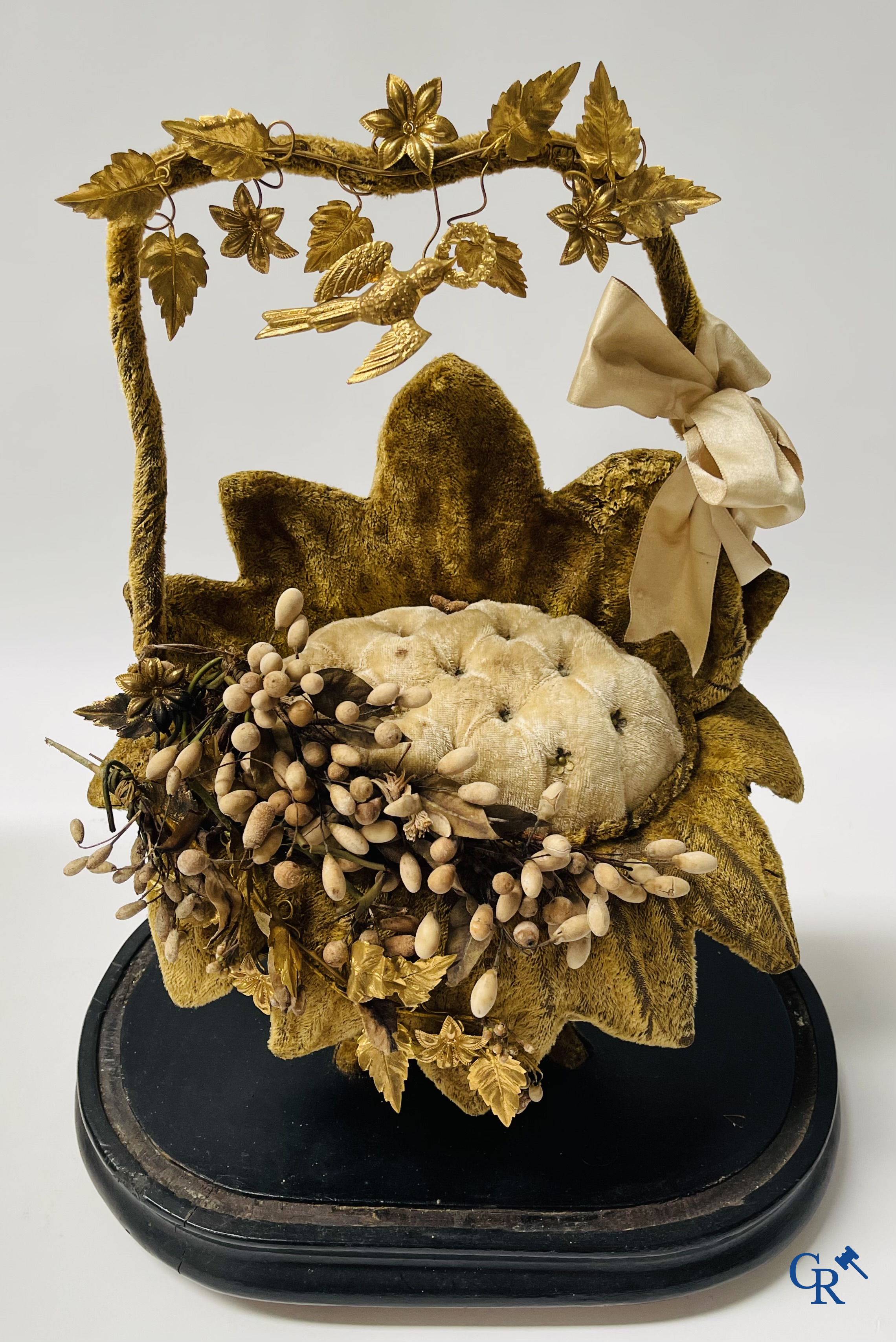 2 glass domes with a bridal bouquet on a base decorated with ornaments in gilded brass. circa 1900.
