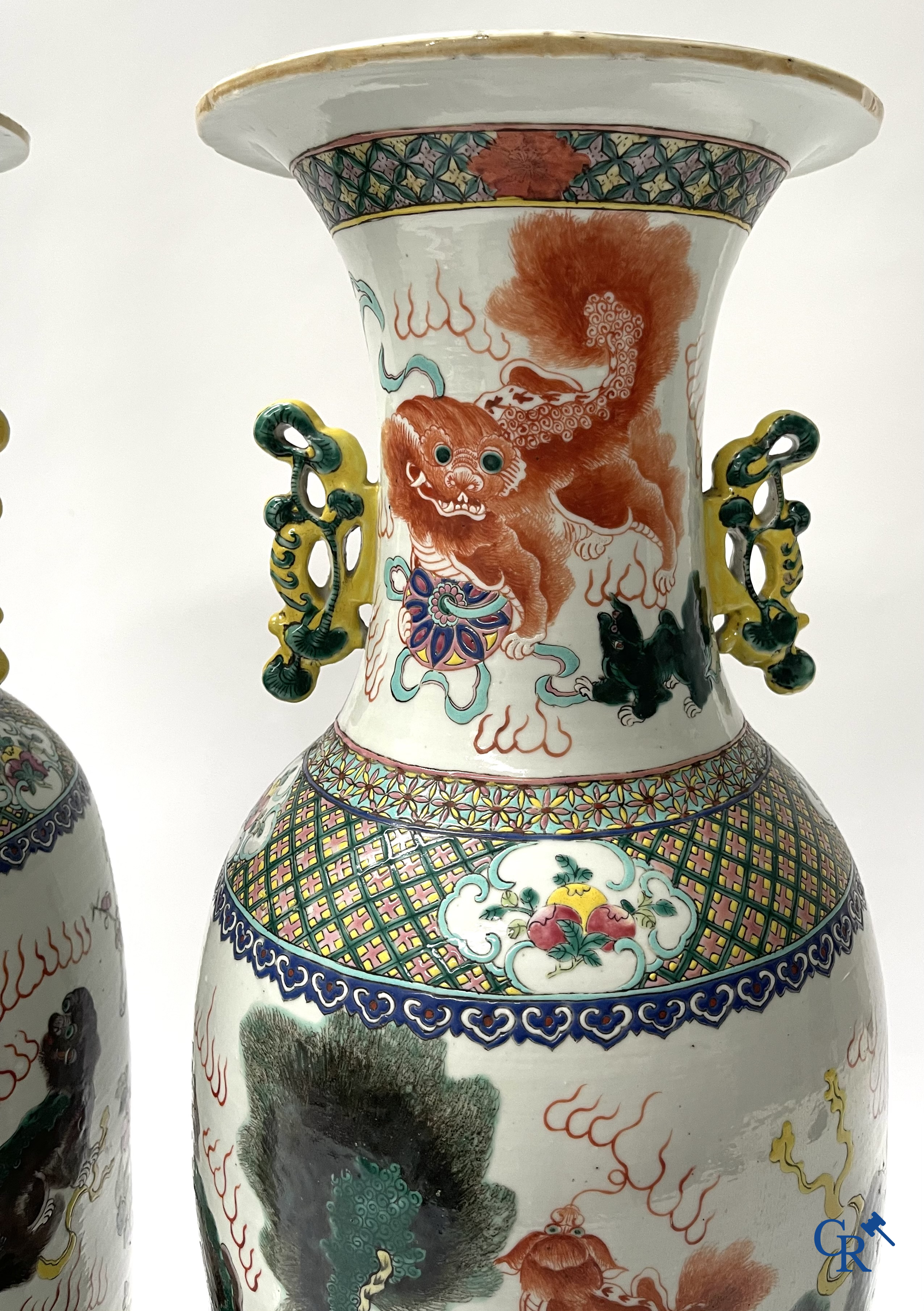 Asian Art, A pair of Chinese famille rose vases with peacocks and Fo dogs. 19th century.