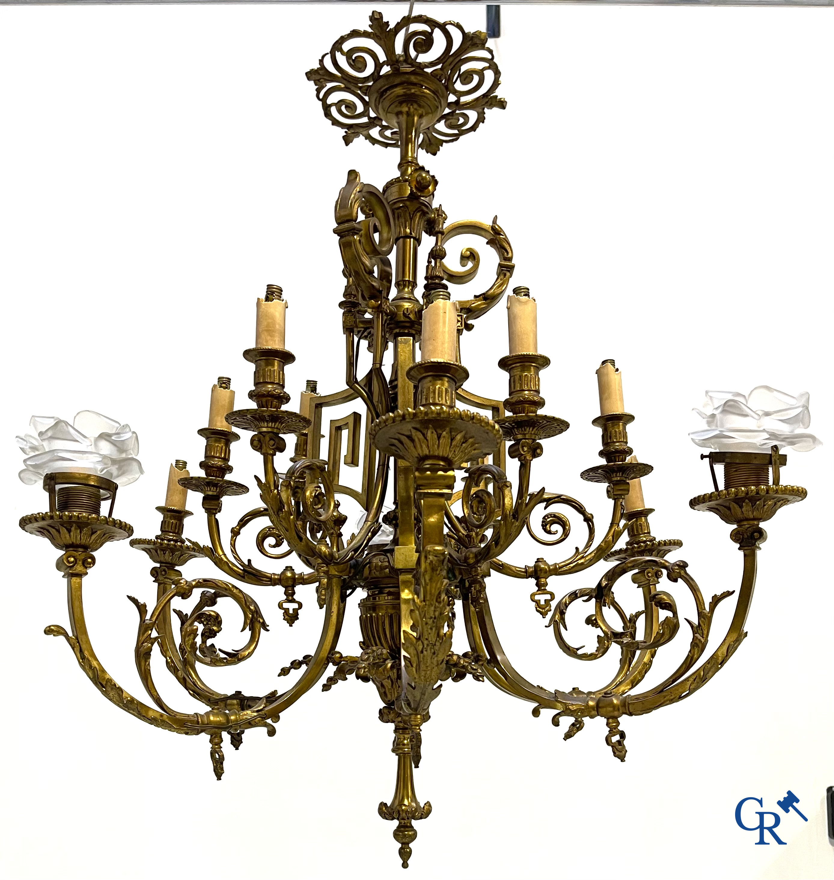 A lot of an imposing chandelier with 12 light points, a lamp belge with bronze frame and a fireplace piece.