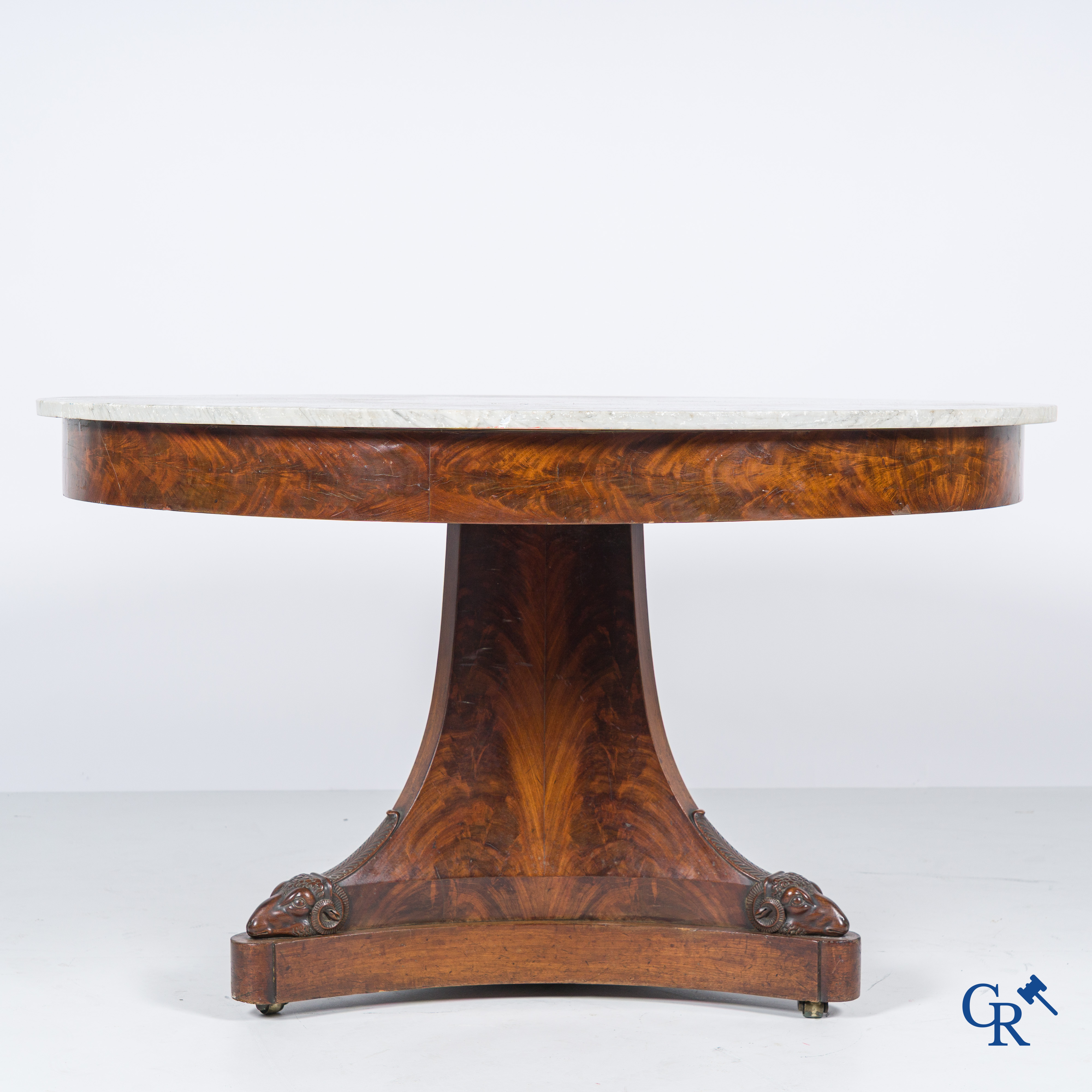 Large round three-legged table with ram heads in mahogany and white marble top. Empire period. 1st quarter 19th century.