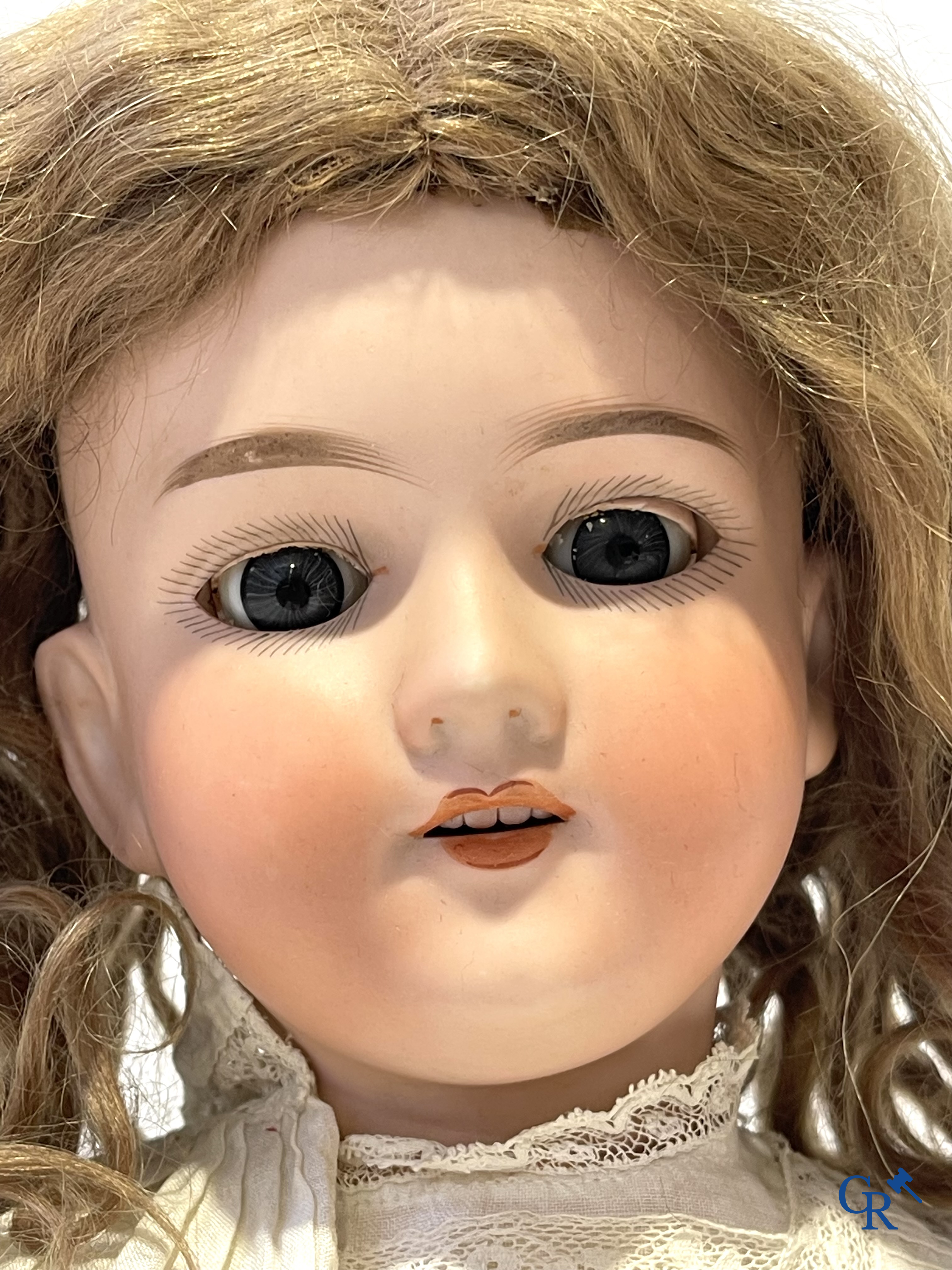 Old toys, an antique doll with porcelain head marked Armand Marseille and a bust in papier-mâché.