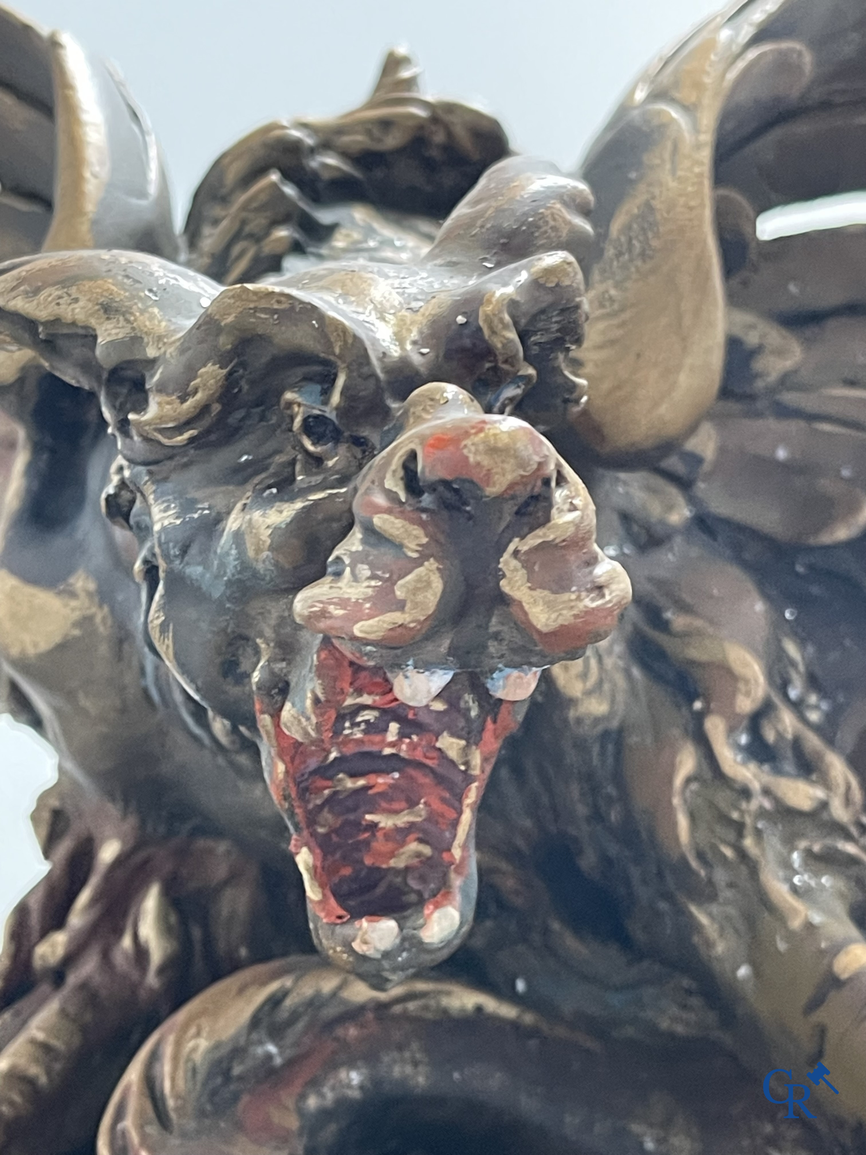 A large patinated fireplace mirror with a dragon. Around 1900.