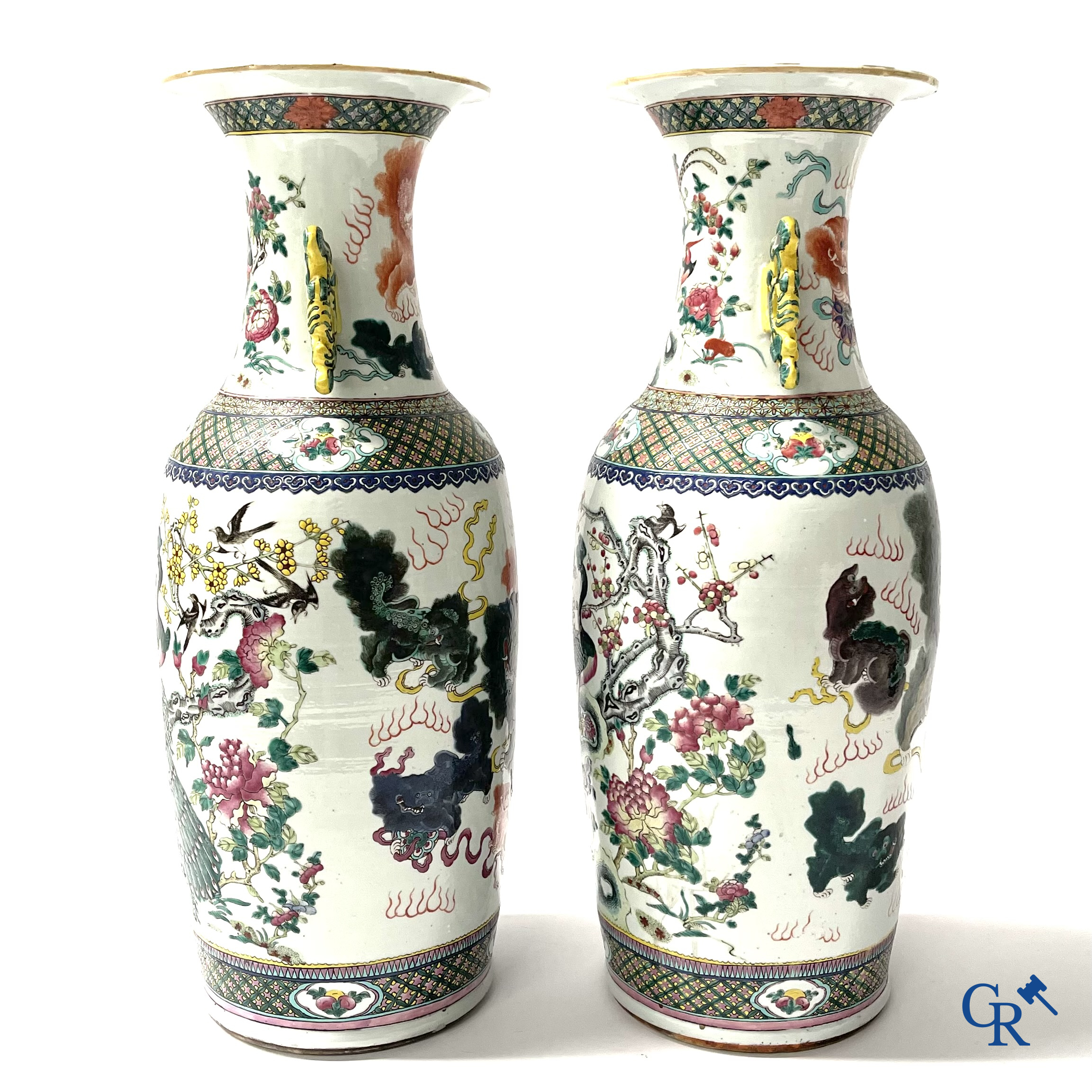 Asian Art, A pair of Chinese famille rose vases with peacocks and Fo dogs. 19th century.