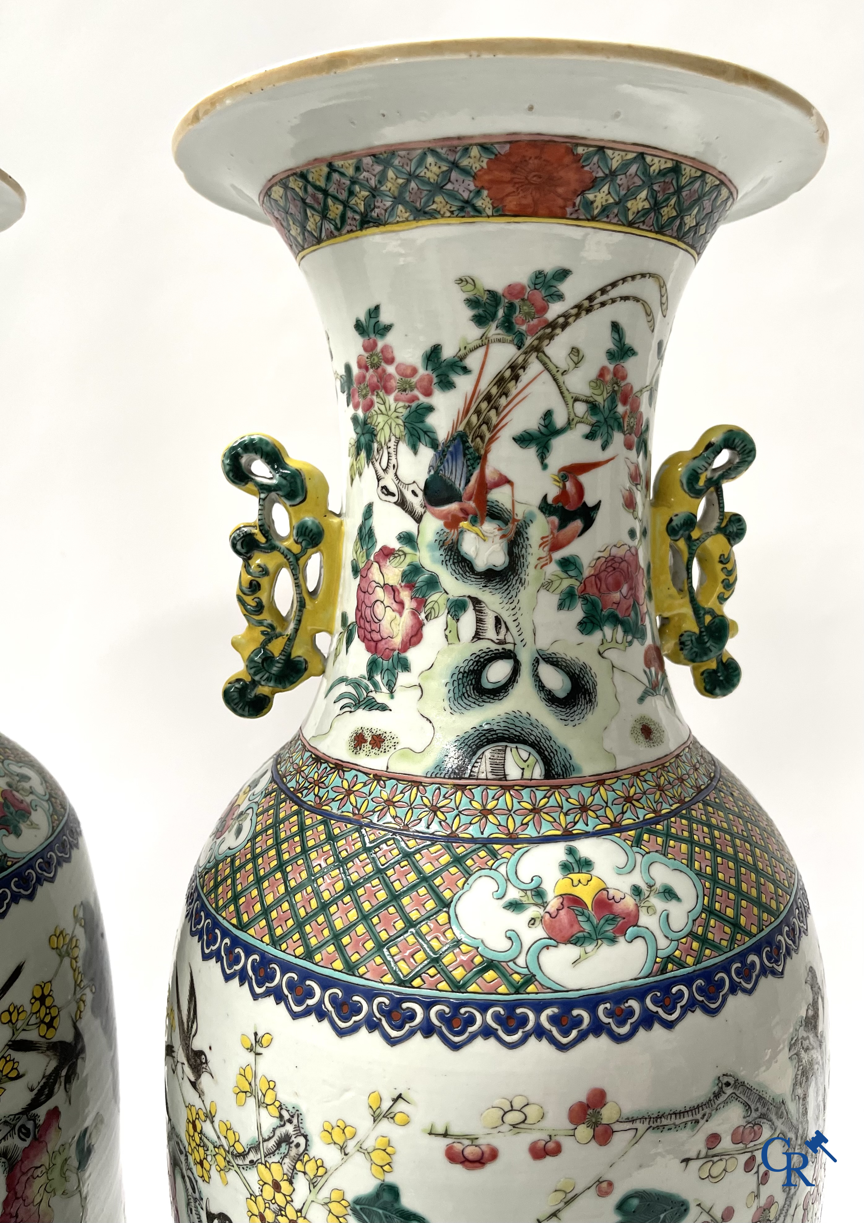 Asian Art, A pair of Chinese famille rose vases with peacocks and Fo dogs. 19th century.