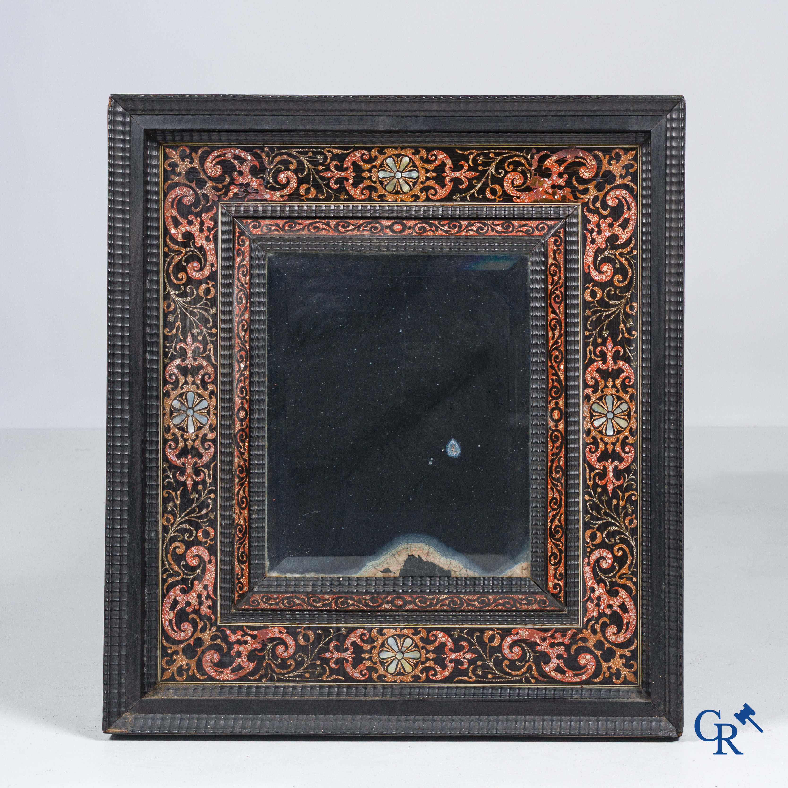 A mirror in ebony and inlay. 18th- 19th century.