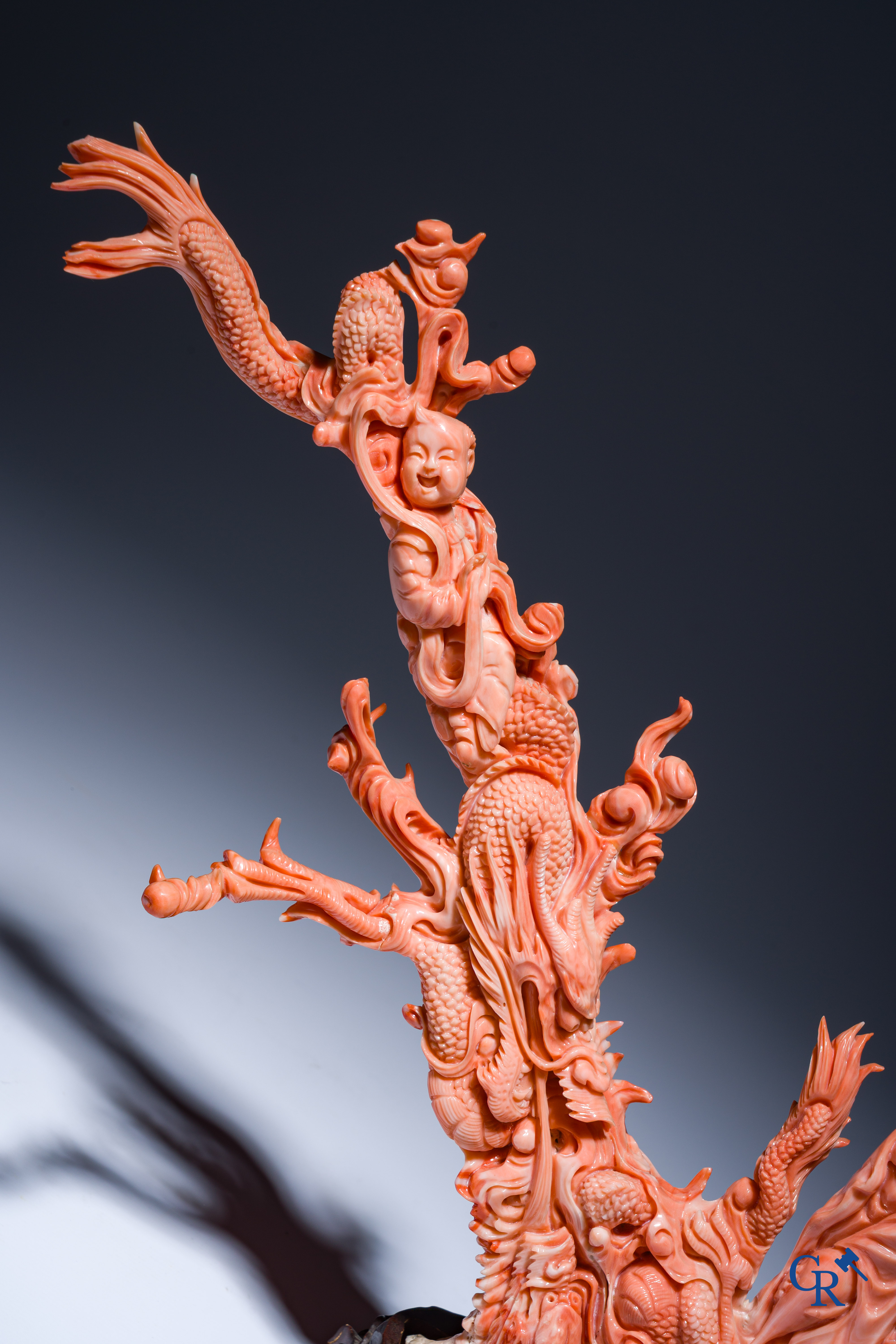 Asian Art, A Chinese group in finely carved red coral with ladies, dragons and children. 19th century.