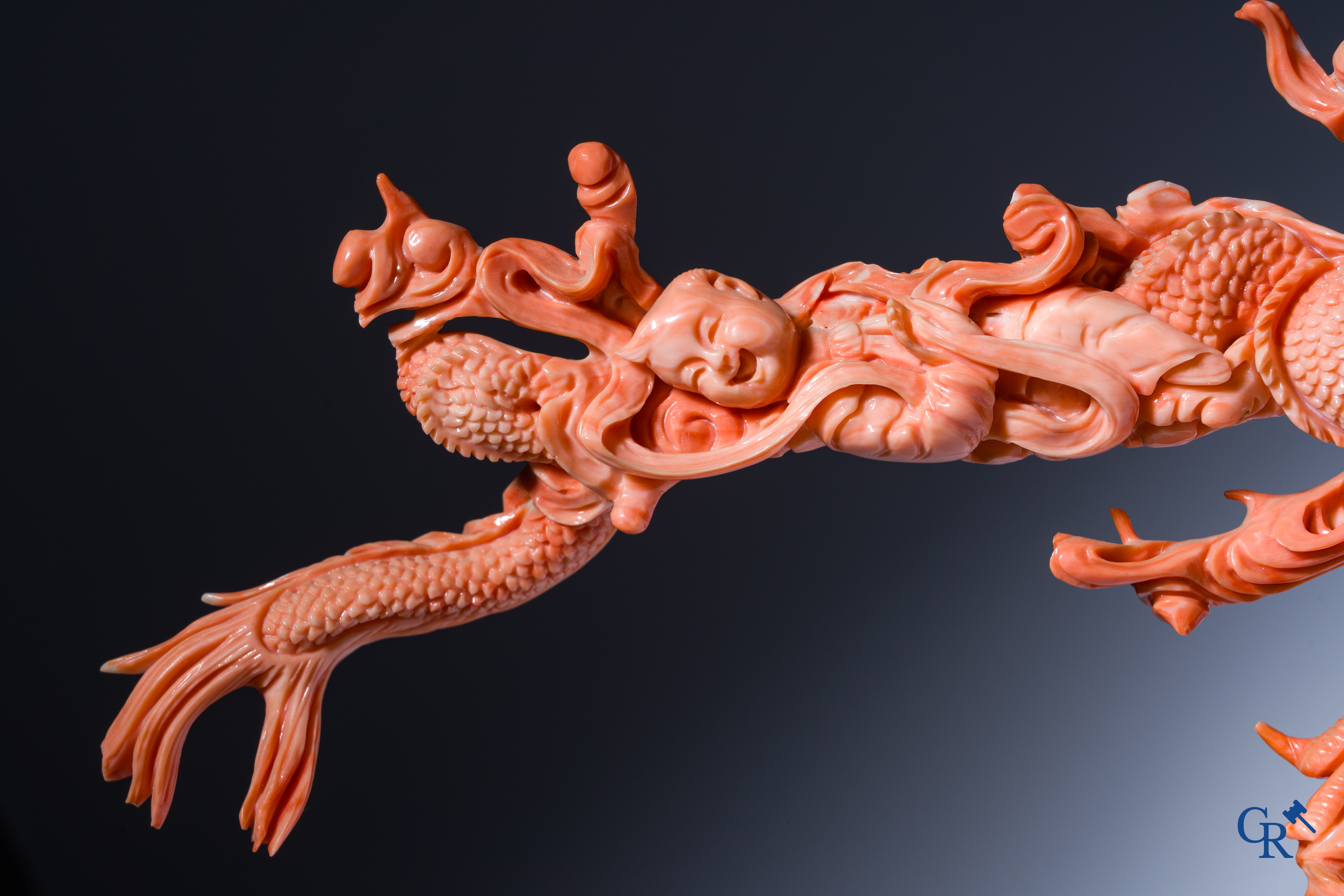 Asian Art, A Chinese group in finely carved red coral with ladies, dragons and children. 19th century.