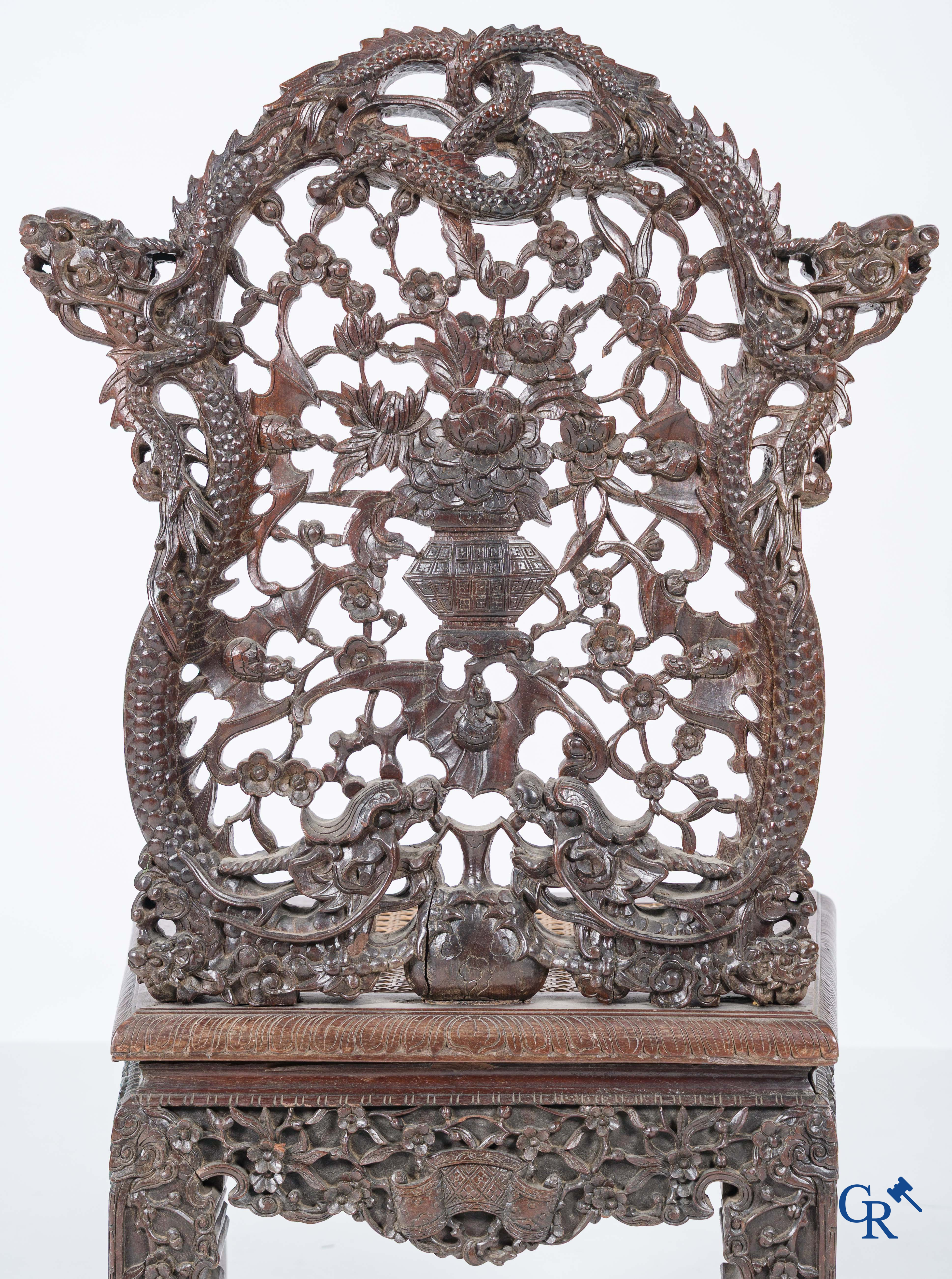 Asian Art, A pair of richly carved chairs with bats, dragons and flowers in Chinese hardwood. 19th century.