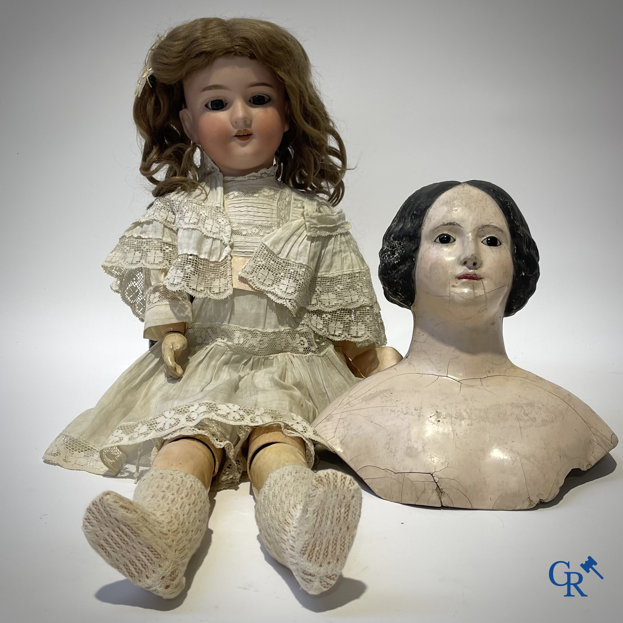 Old toys, an antique doll with porcelain head marked Armand Marseille and a bust in papier-mâché.