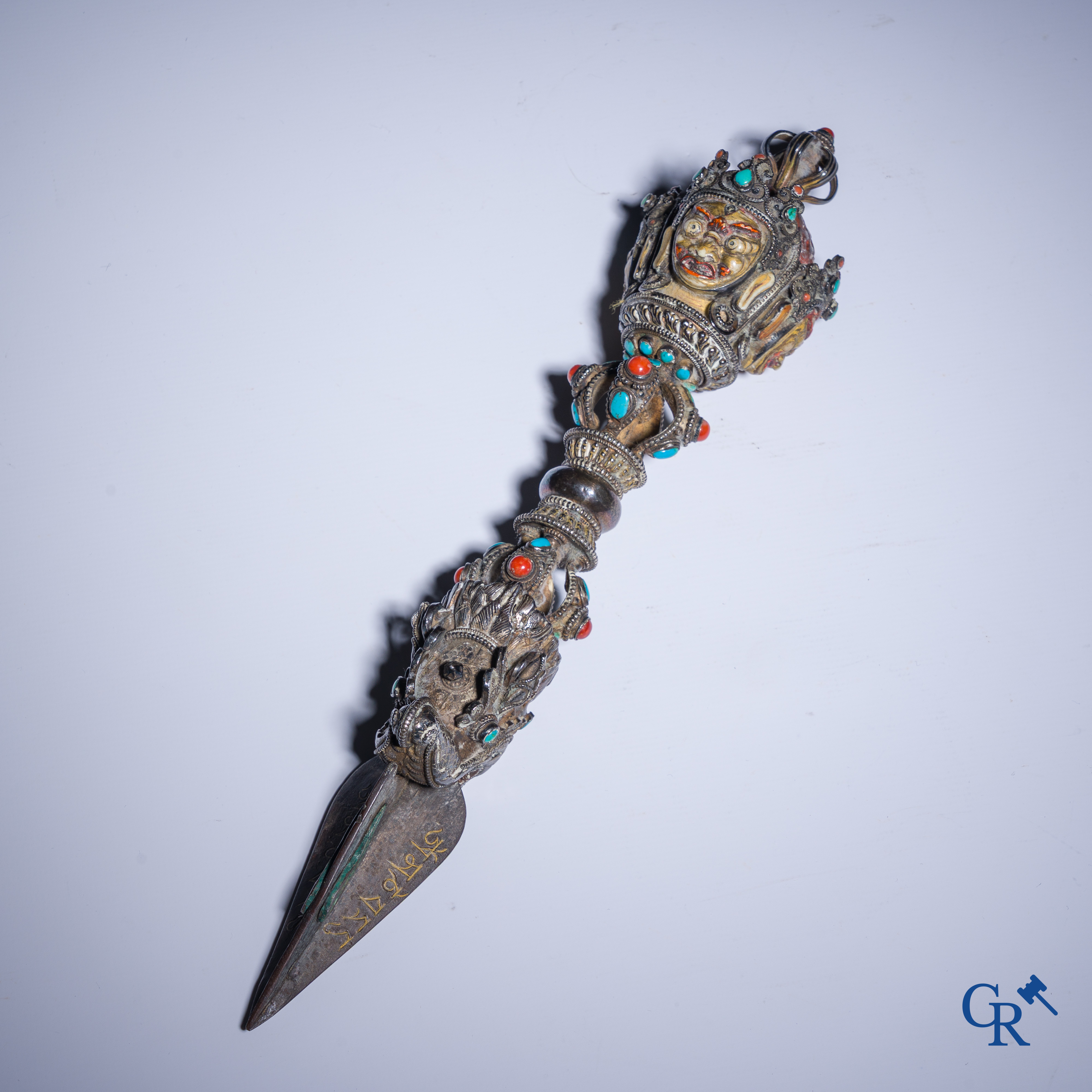 Asian Art, Phurba. Tibetan ritual dagger in silver, inlaid with turquoise and red coral.