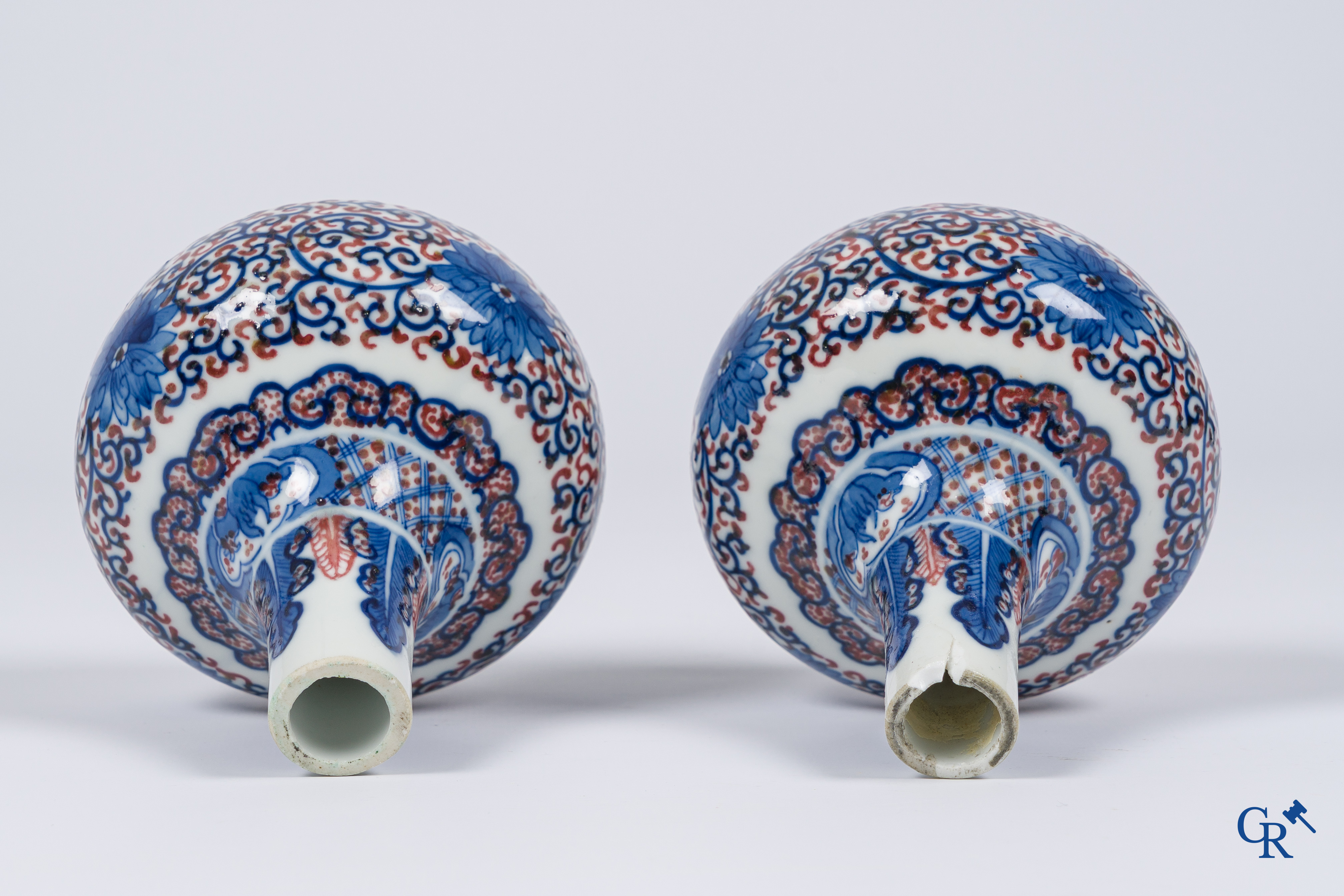 Asian Art, Chinese porcelain. A pair of blue-white and iron-red decorated vases with bats and a dragon bottom mark.