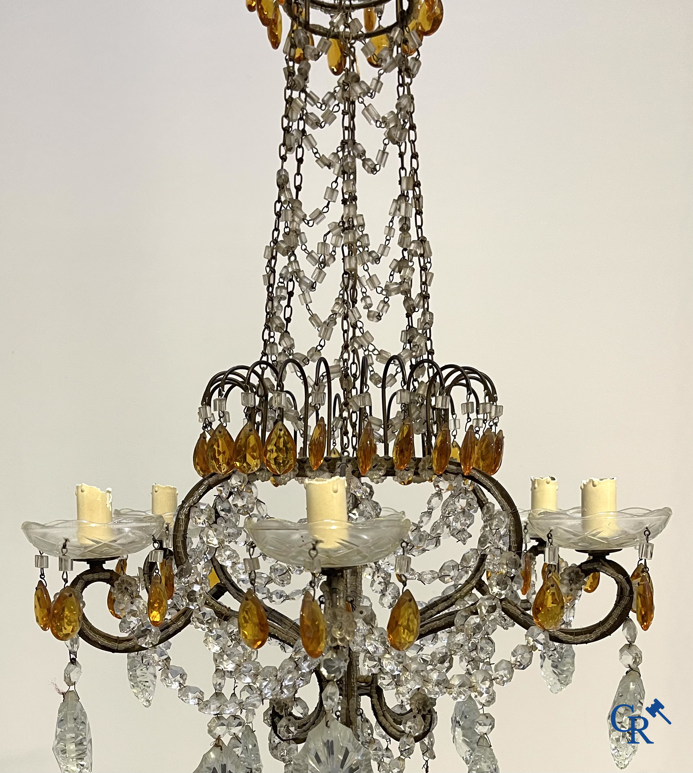 A large chandelier in crystal with double pearls on the frame.