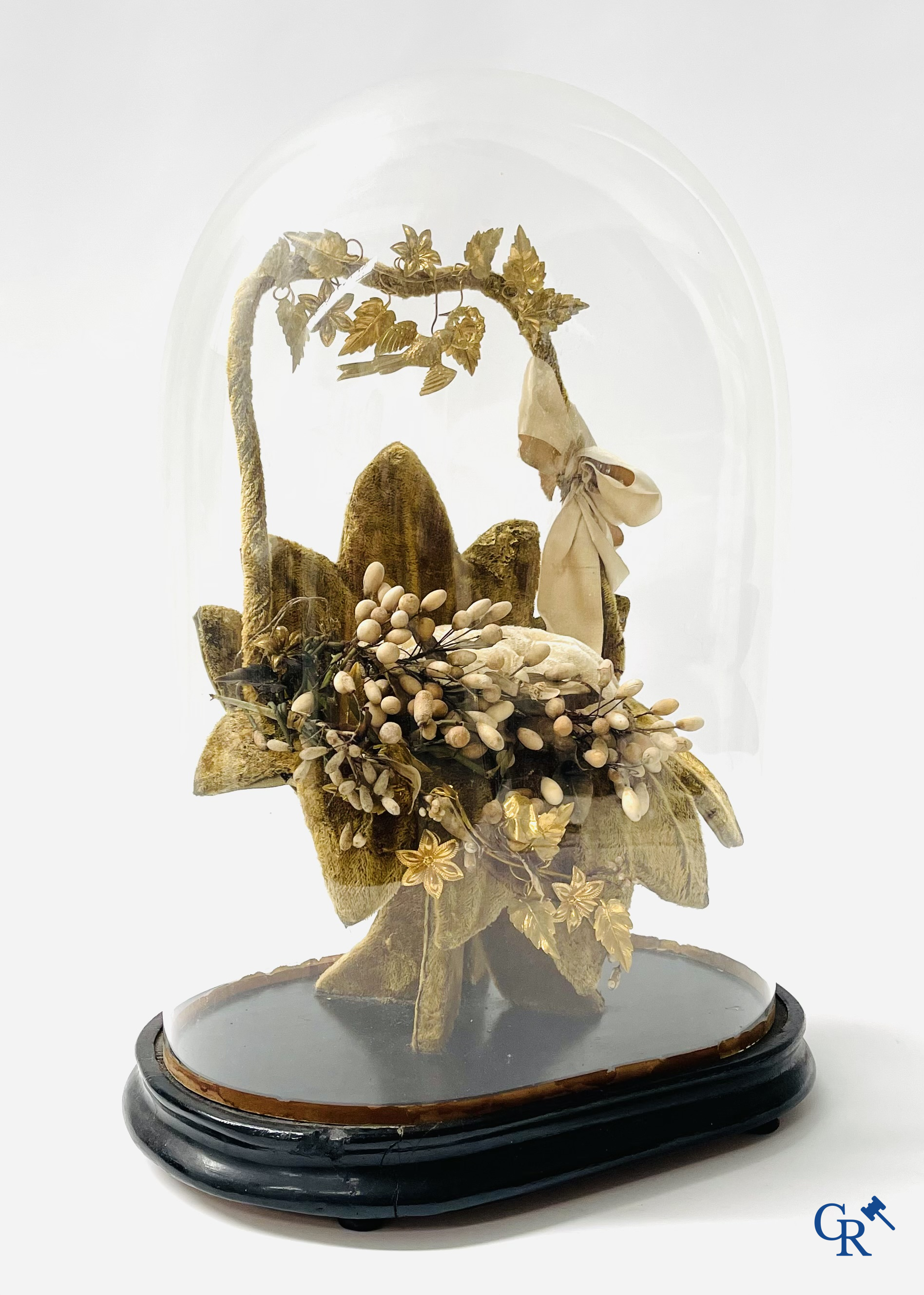 2 glass domes with a bridal bouquet on a base decorated with ornaments in gilded brass. circa 1900.