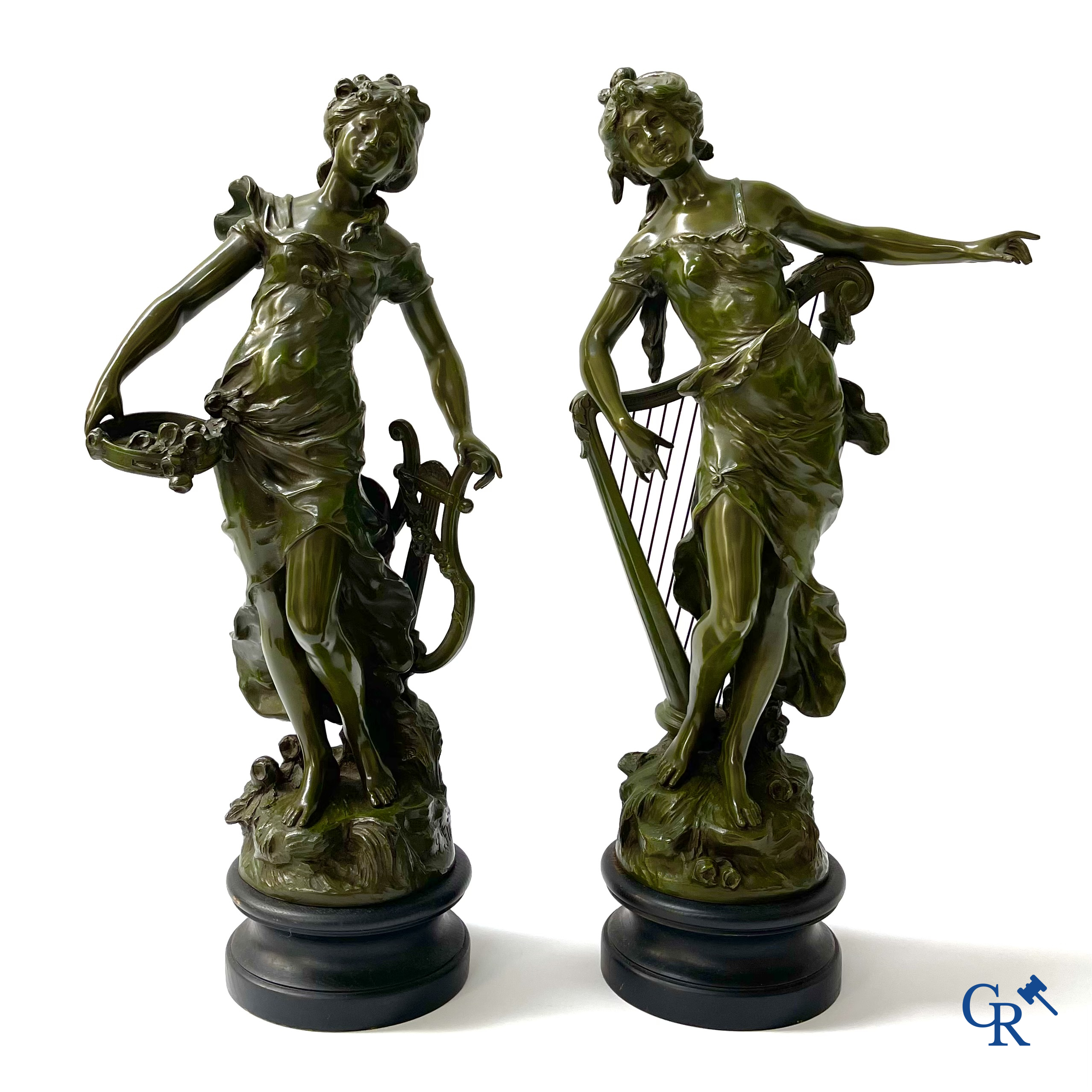 Louis & François Moreau, A large pair of statues in green patinated spelter on a wooden base. Signed L&F Moreau.