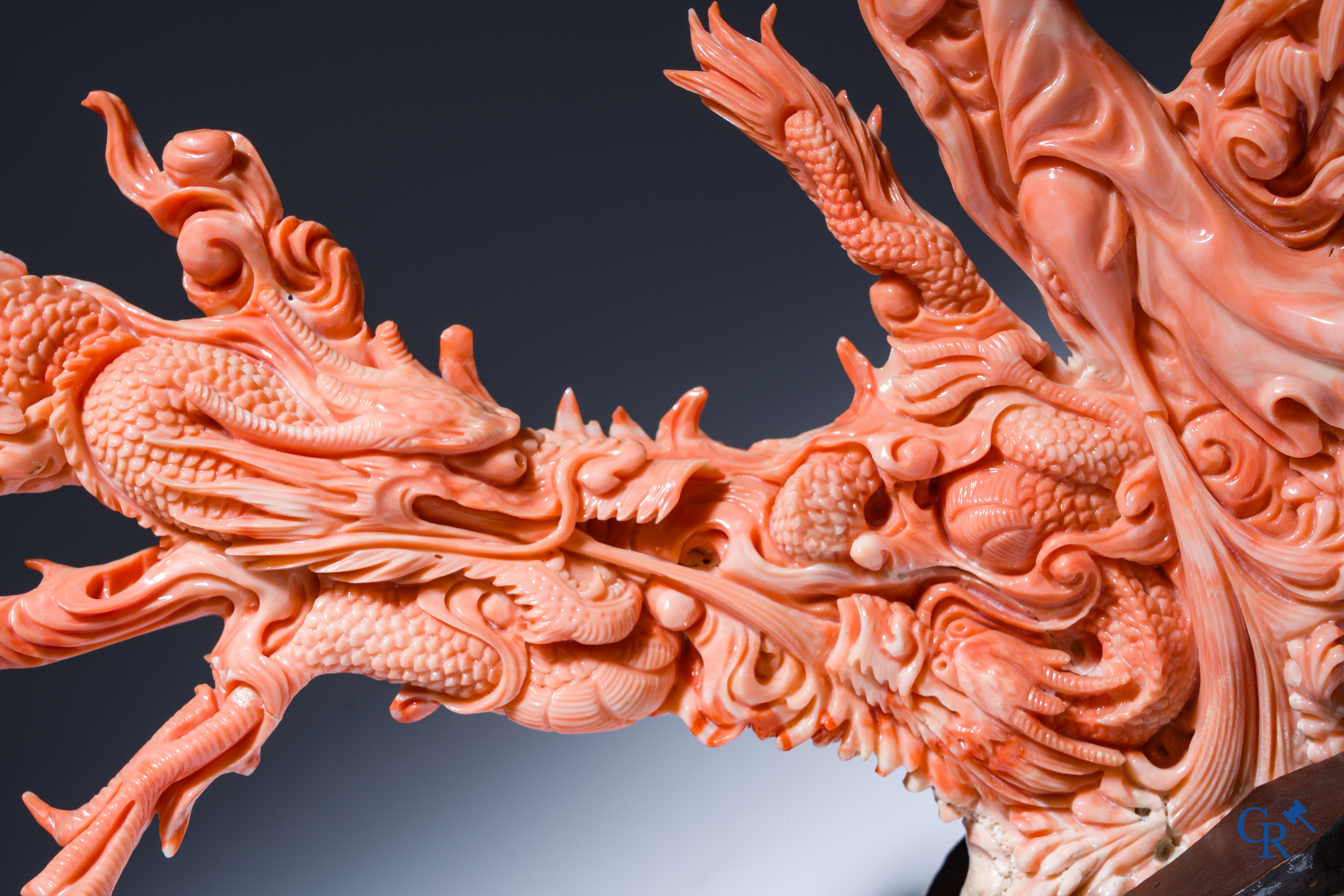 Asian Art, A Chinese group in finely carved red coral with ladies, dragons and children. 19th century.