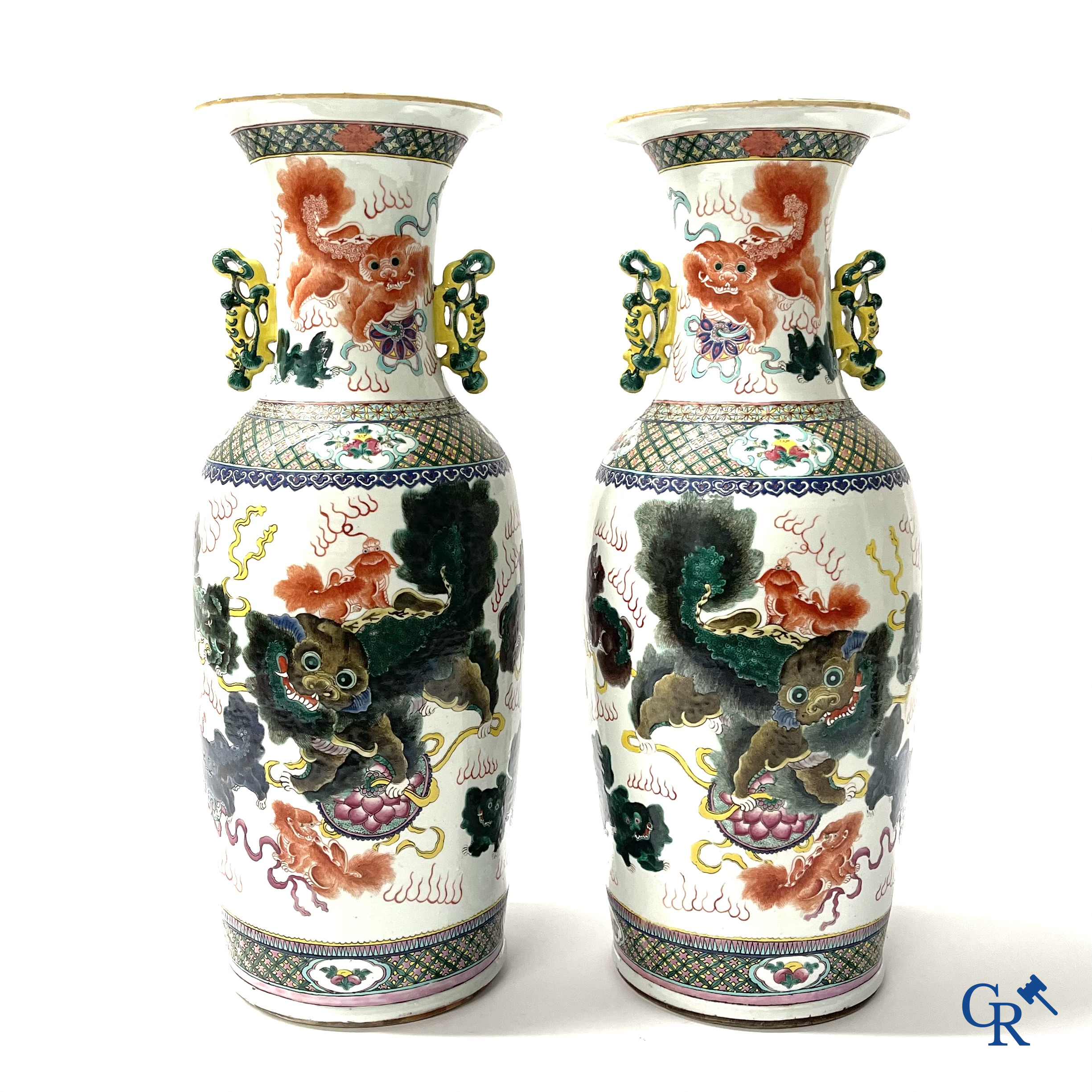 Asian Art, A pair of Chinese famille rose vases with peacocks and Fo dogs. 19th century.