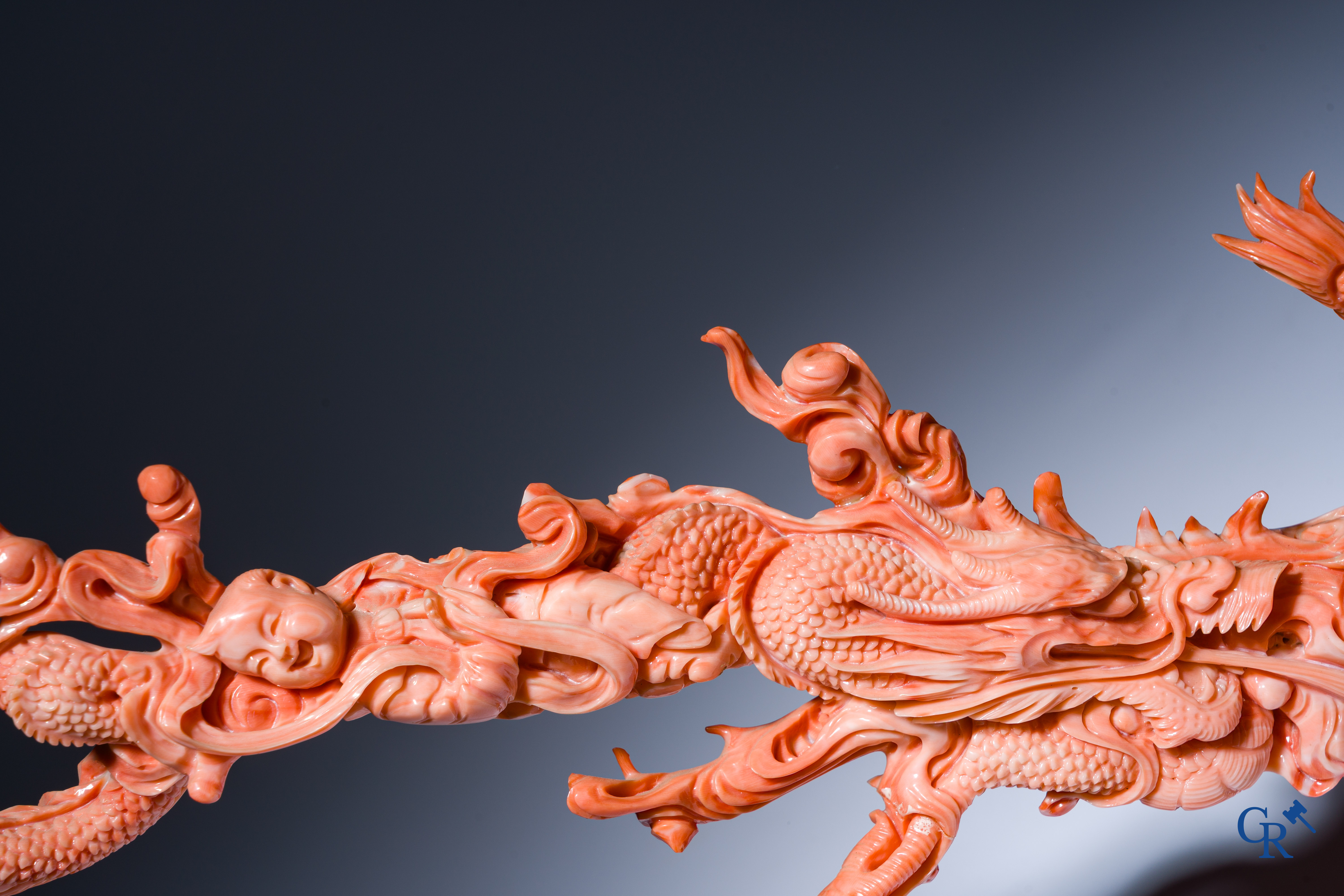 Asian Art, A Chinese group in finely carved red coral with ladies, dragons and children. 19th century.