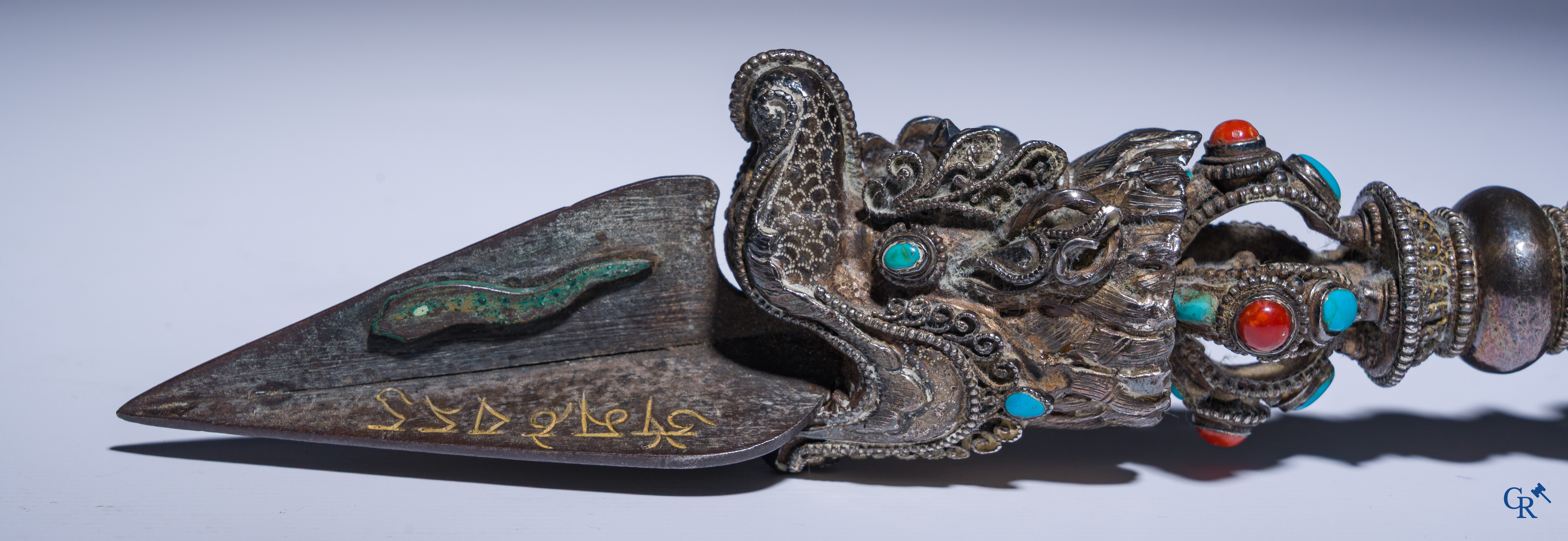 Asian Art, Phurba. Tibetan ritual dagger in silver, inlaid with turquoise and red coral.