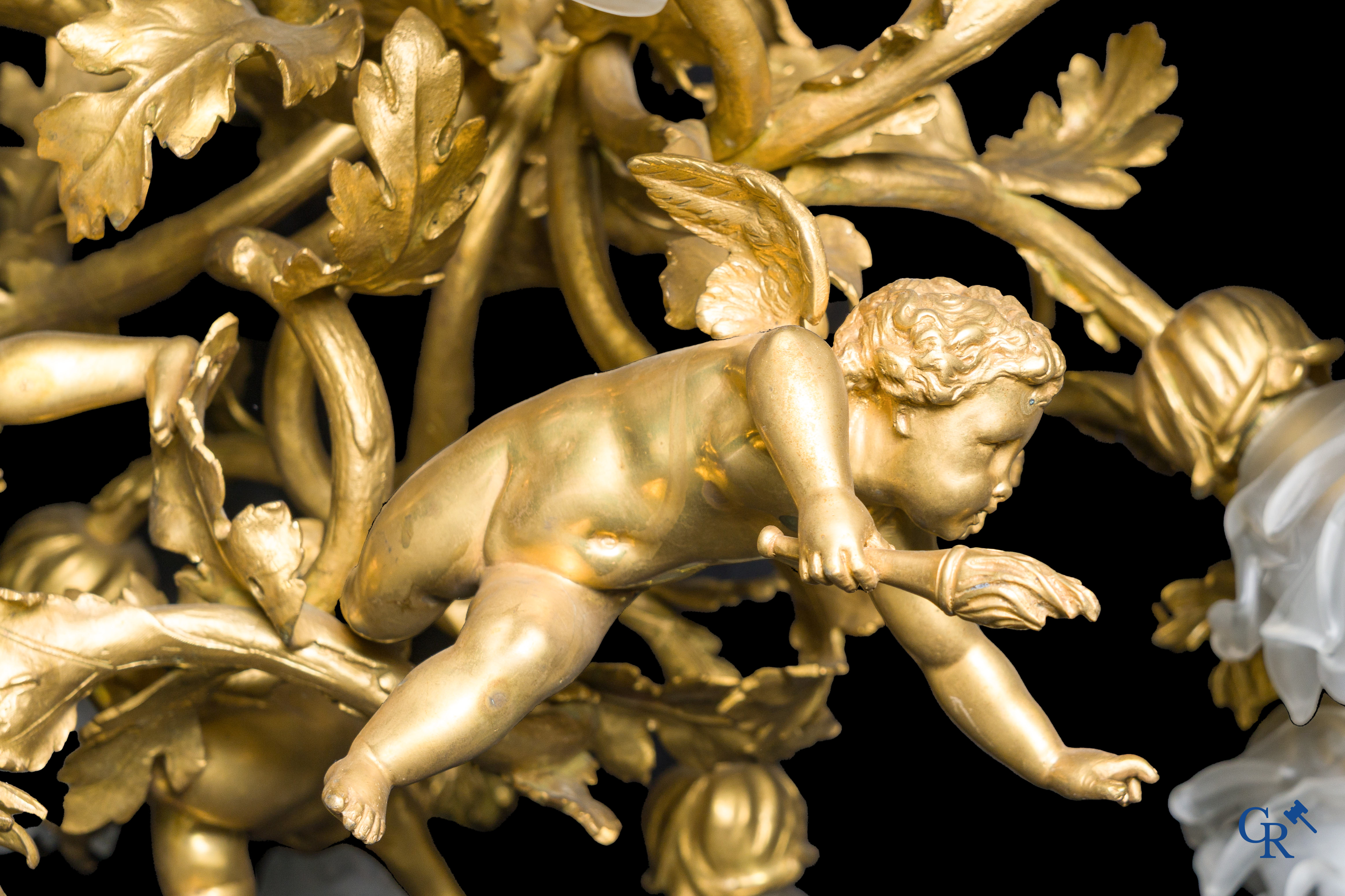 An imposing bronze gilded Napoleon III chandelier with 3 putti and 13 light points. LXVI style.