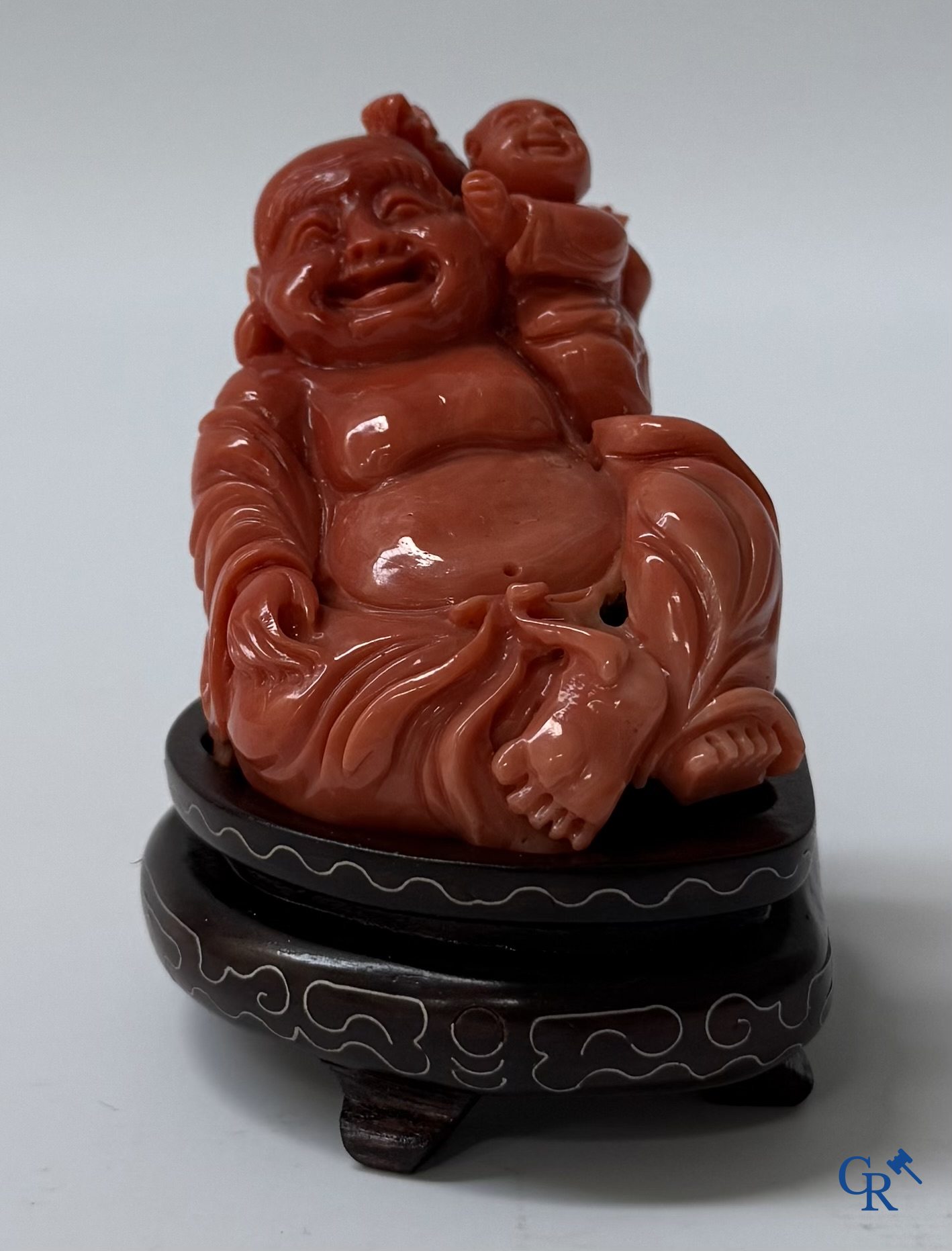 Asian Art, a Chinese carved red coral Buddha figure with child.