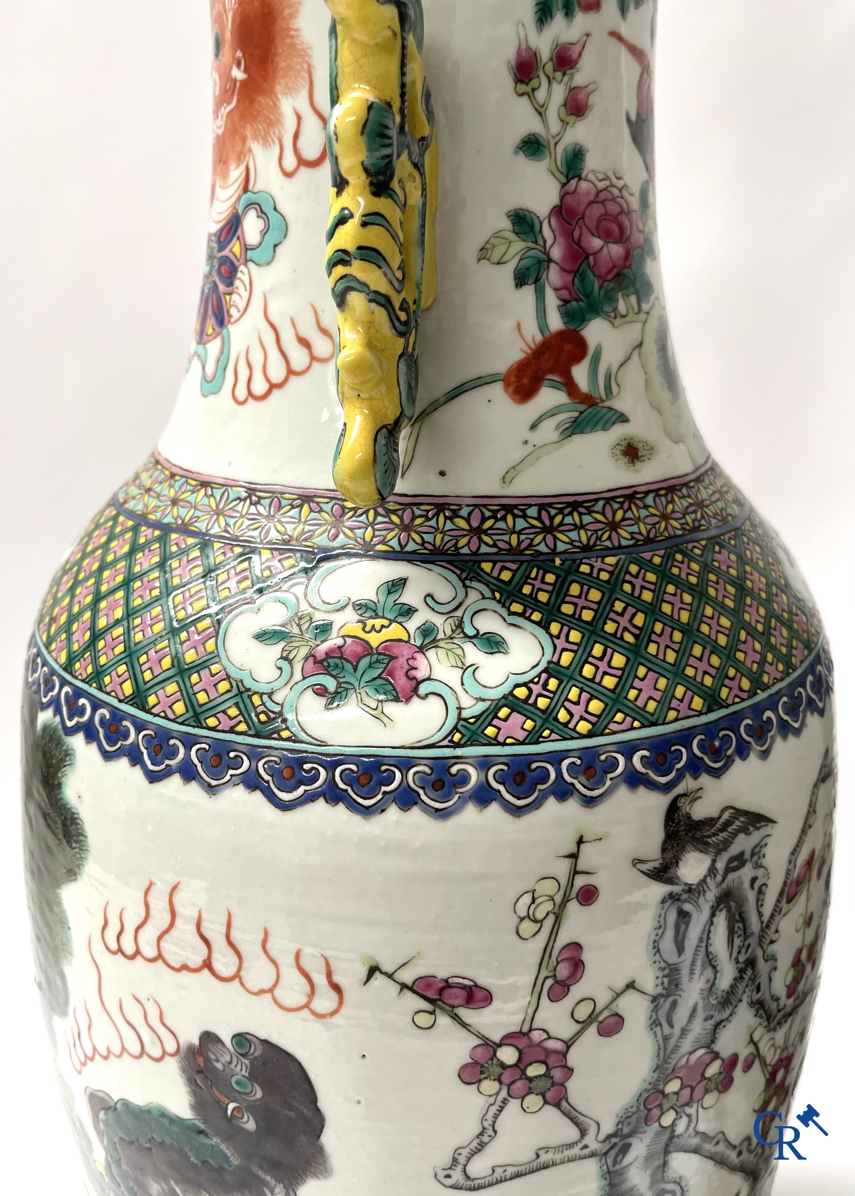 Asian Art, A pair of Chinese famille rose vases with peacocks and Fo dogs. 19th century.