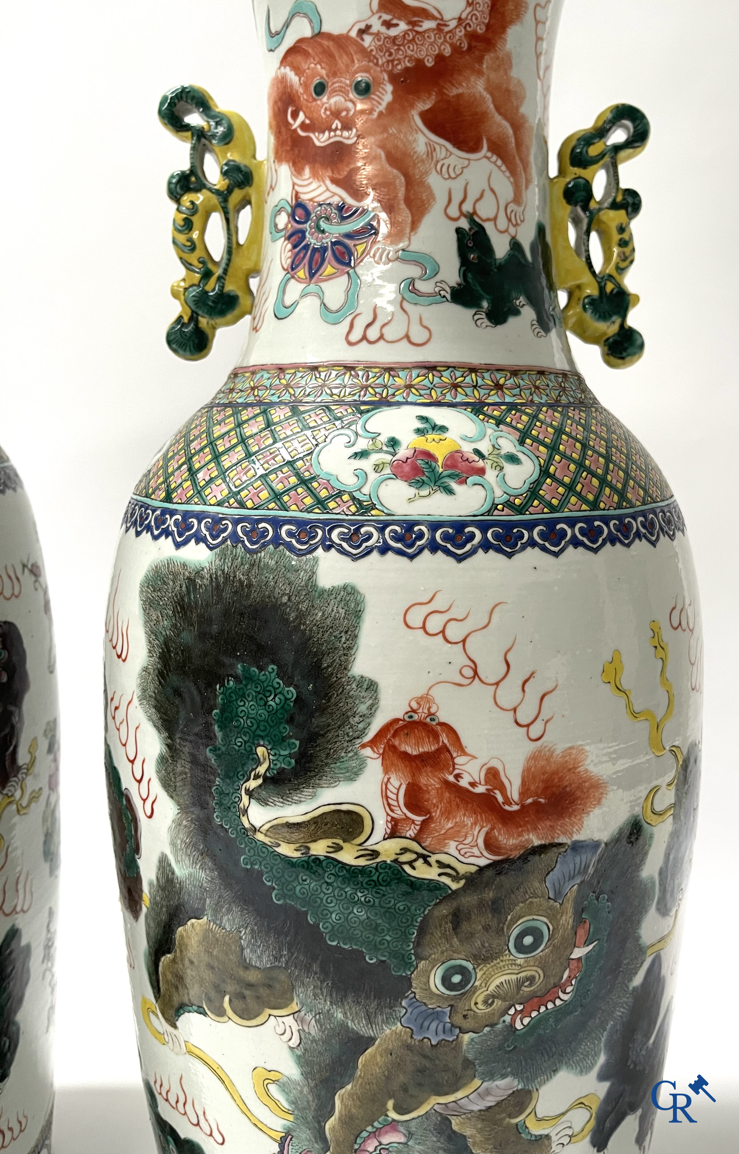 Asian Art, A pair of Chinese famille rose vases with peacocks and Fo dogs. 19th century.