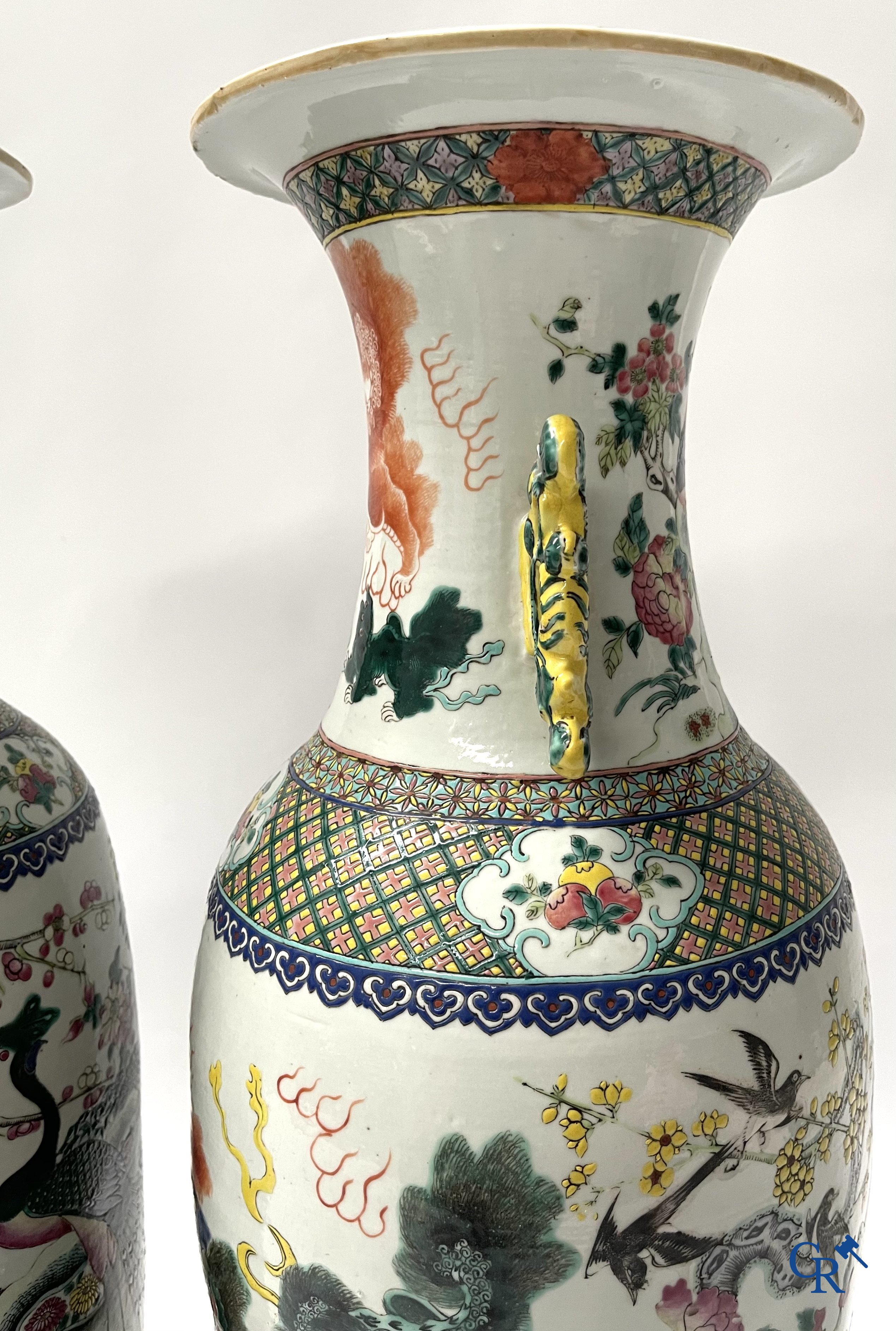 Asian Art, A pair of Chinese famille rose vases with peacocks and Fo dogs. 19th century.