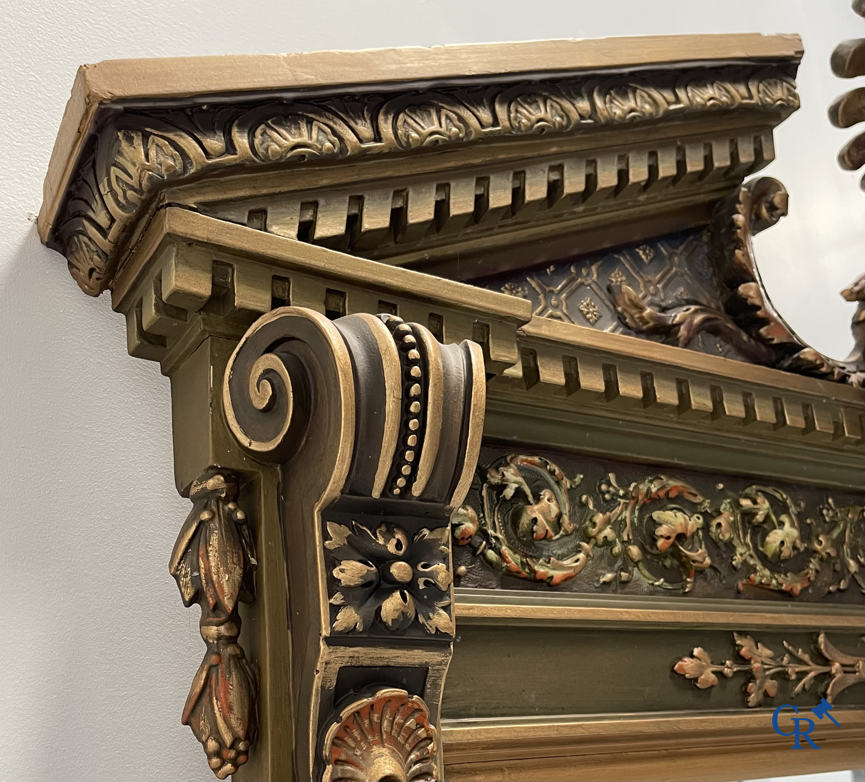 A large patinated fireplace mirror with a dragon. Around 1900.