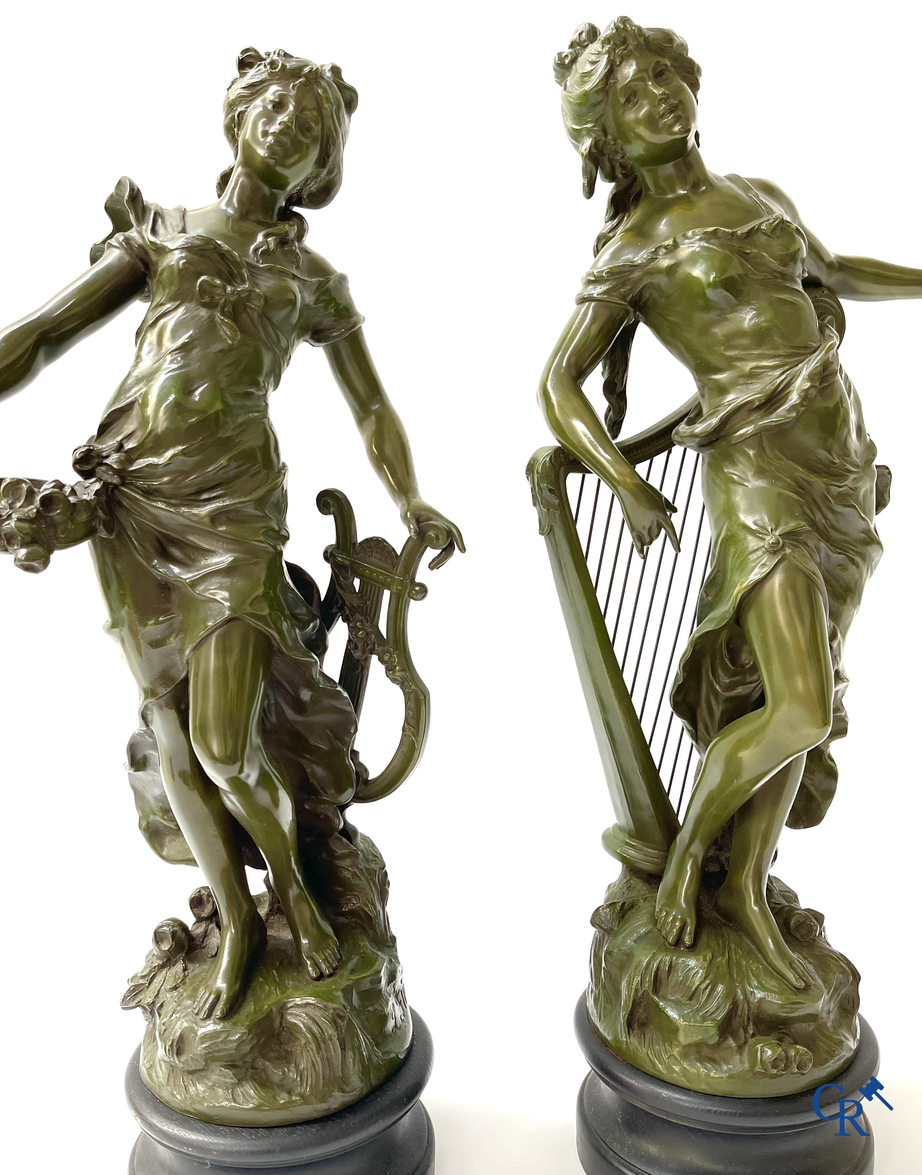 Louis & François Moreau, A large pair of statues in green patinated spelter on a wooden base. Signed L&F Moreau.