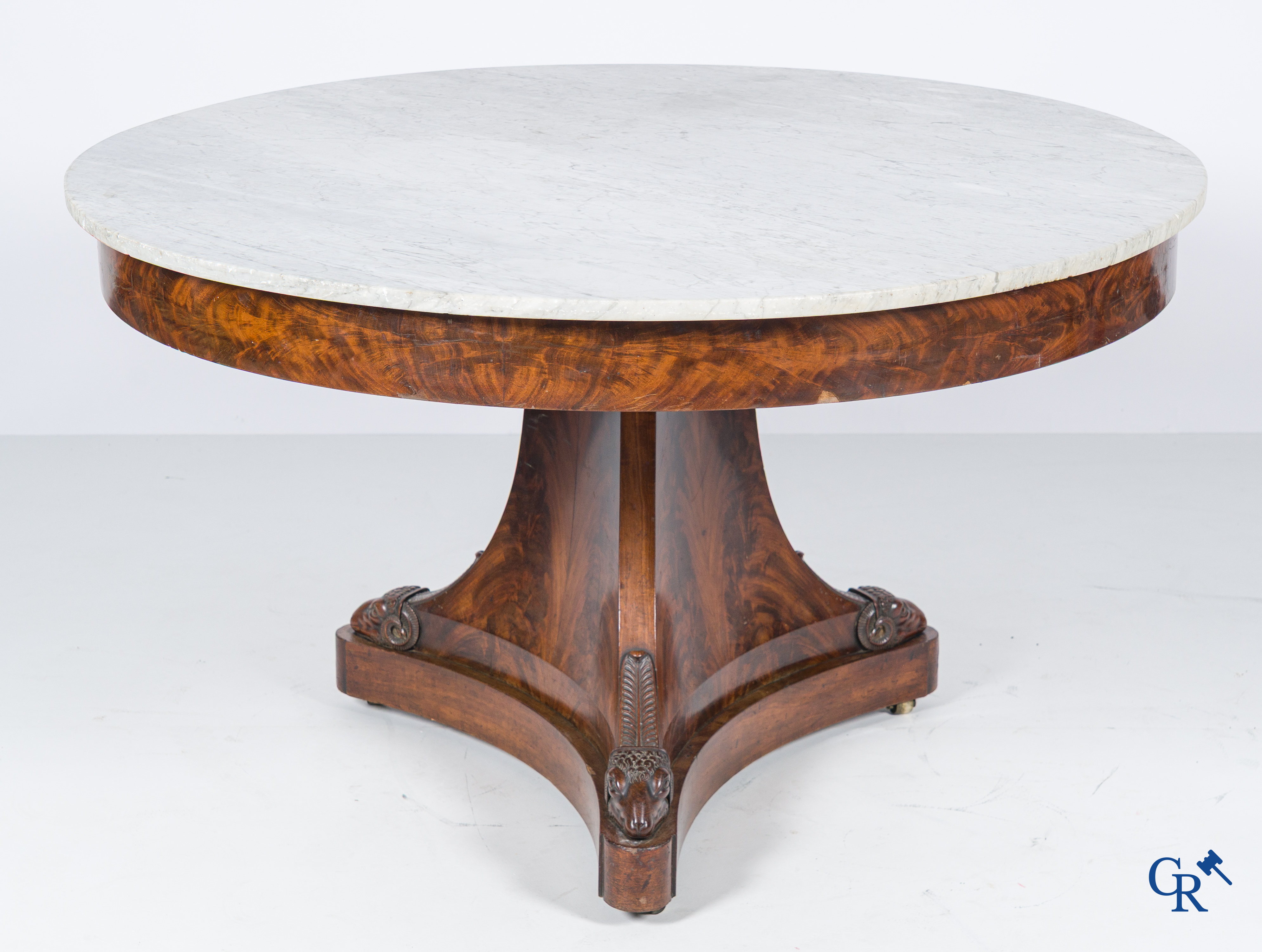 Large round three-legged table with ram heads in mahogany and white marble top. Empire period. 1st quarter 19th century.