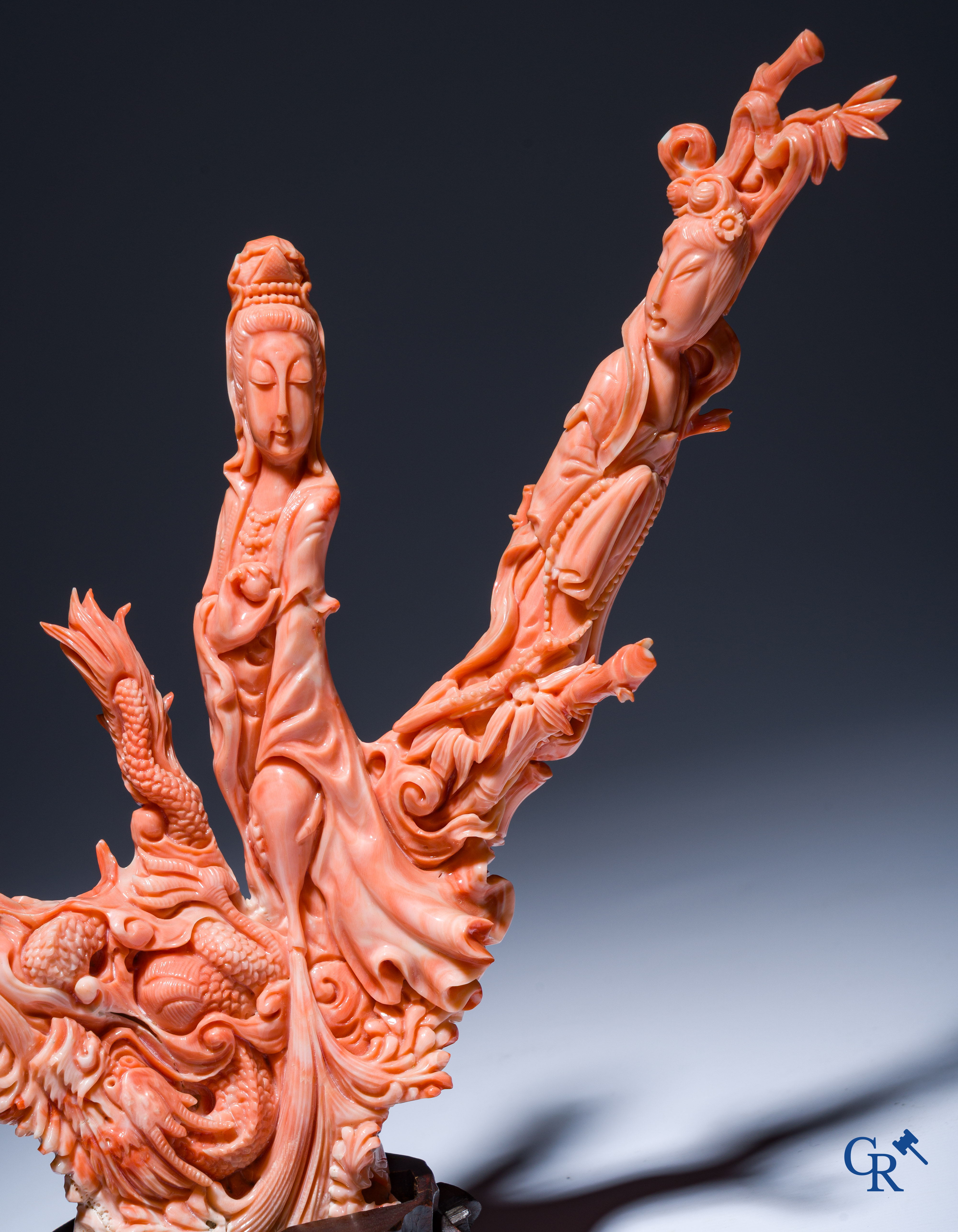 Asian Art, A Chinese group in finely carved red coral with ladies, dragons and children. 19th century.