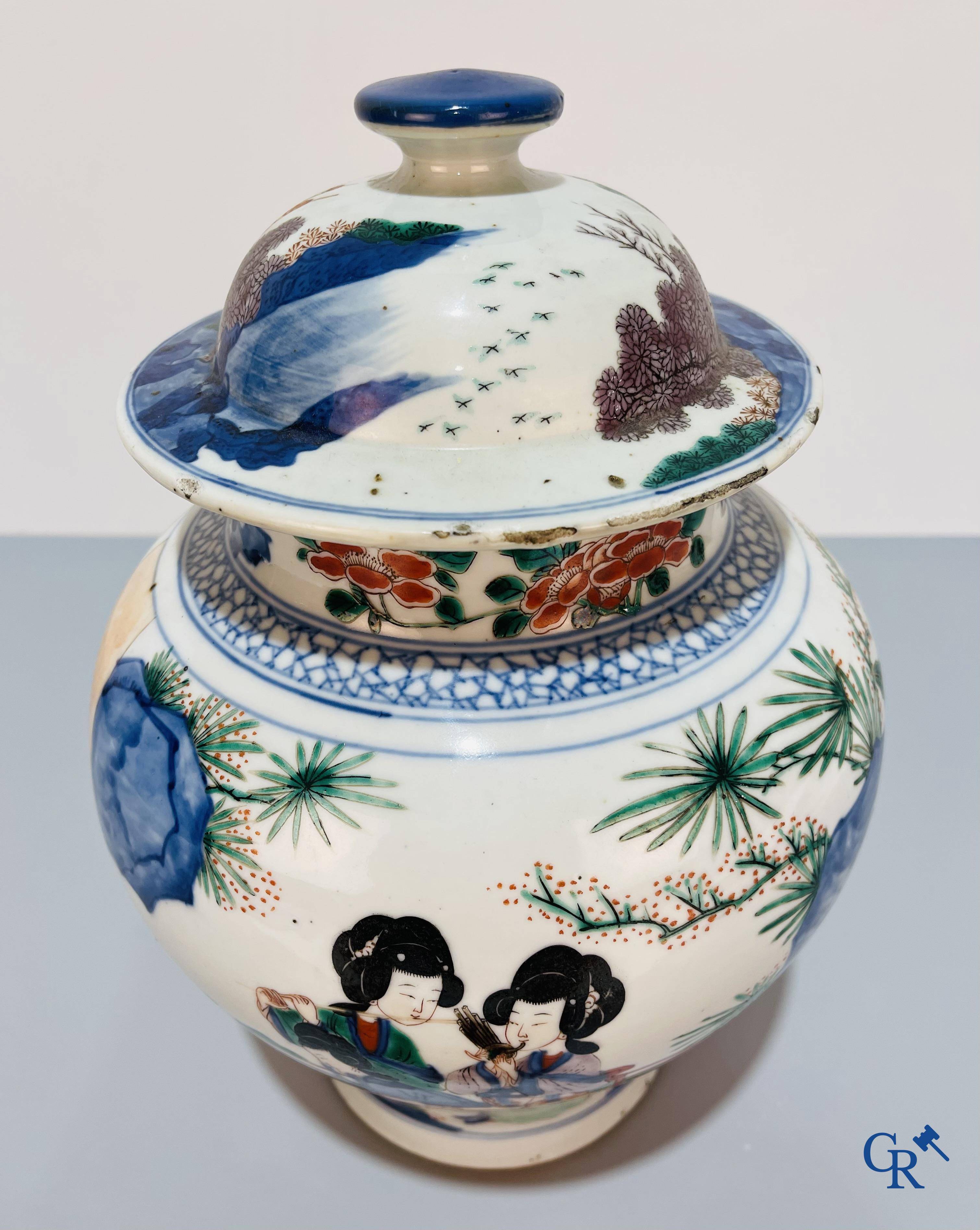 Asian Art, Chinese porcelain, a Chinese Wucai lidded vase with characters.