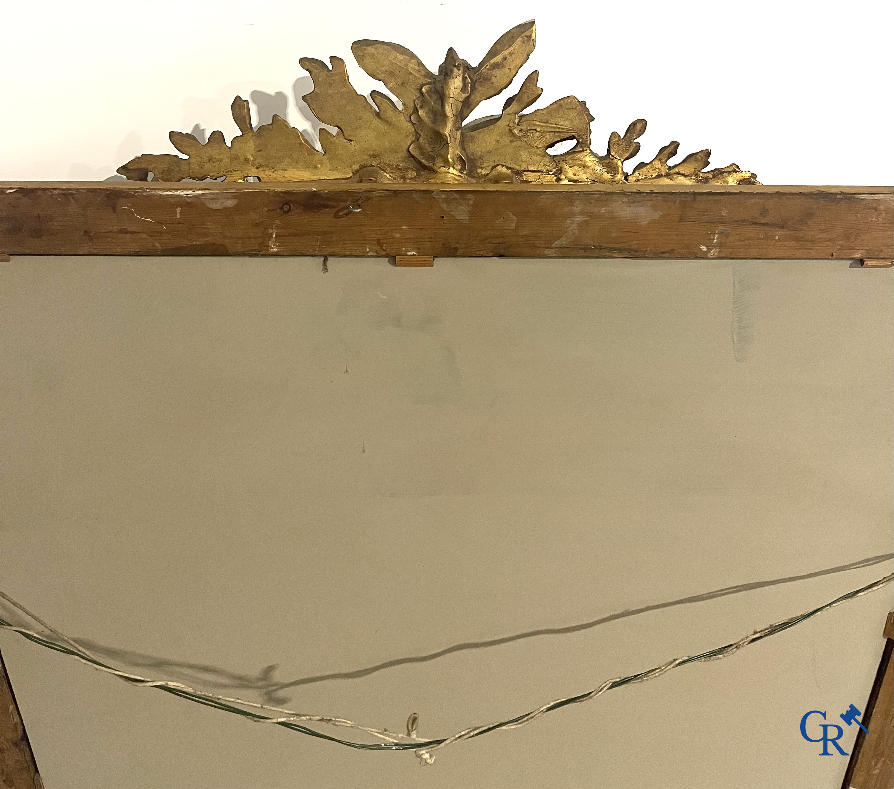 A large gilded fireplace mirror in LXVI style. Circa 1920.
