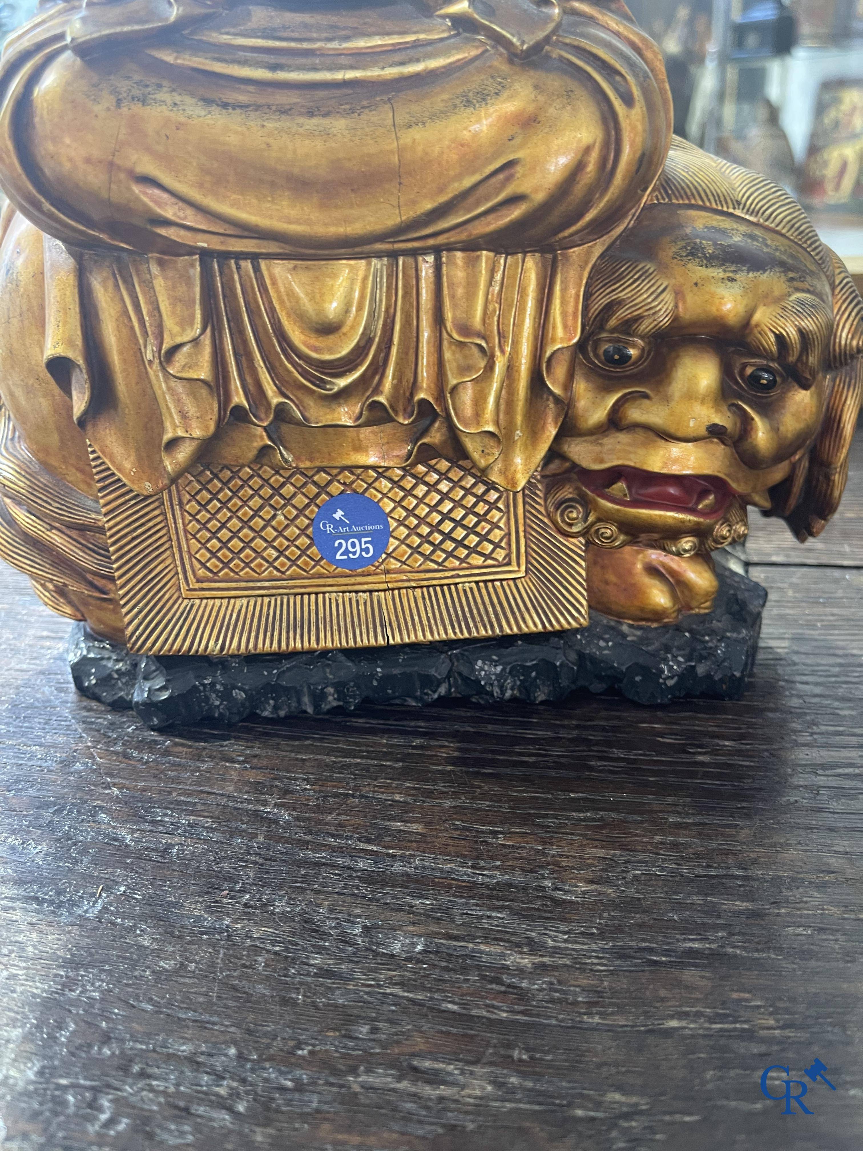 Asian Art: A Chinese sculpture of Vaishravana on a Buddhist lion in lacquered and gilded wood. 19th century.