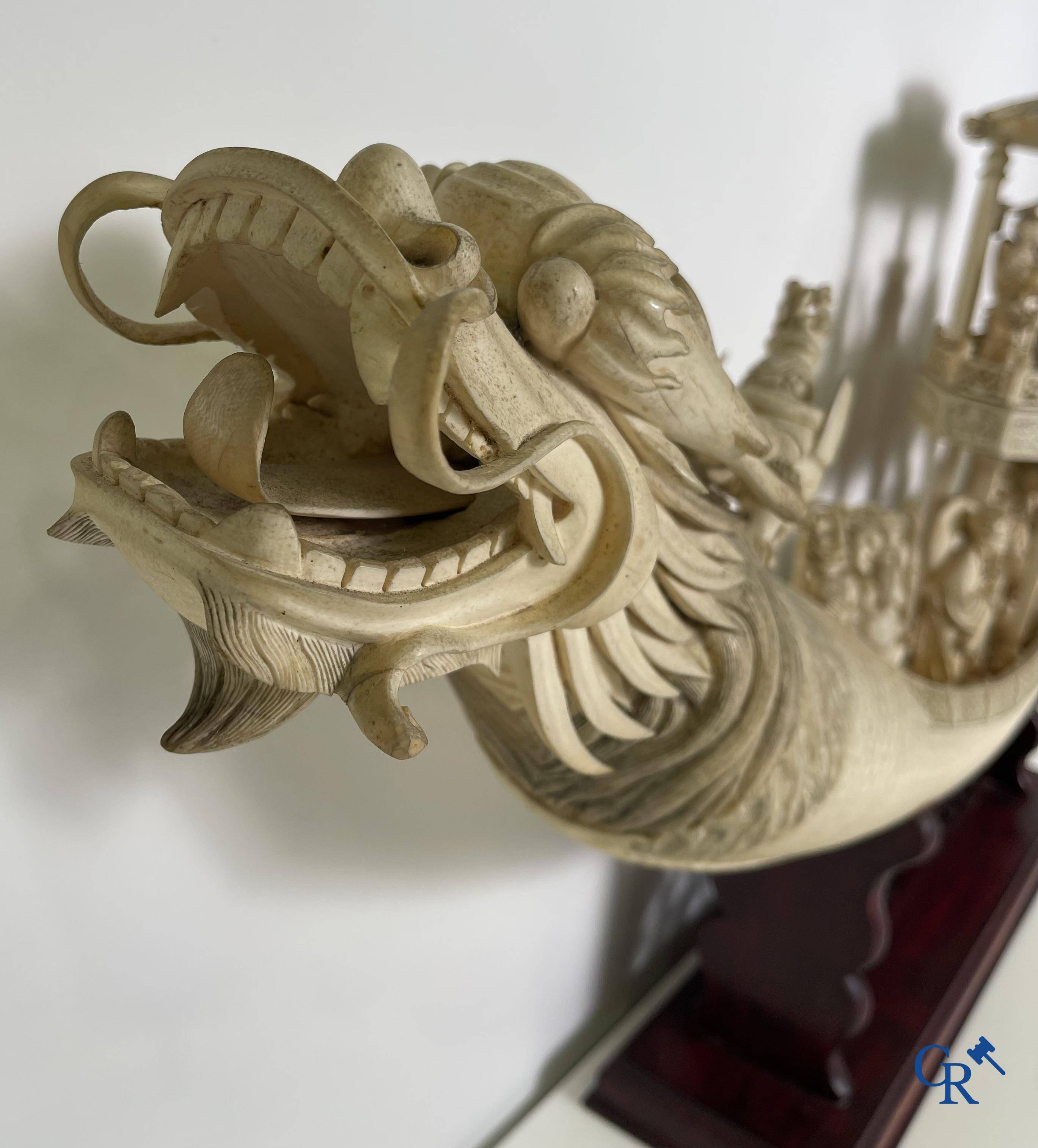 Asian Art: A large Chinese ivory dragon boat on a wooden pedestal. 19th century.