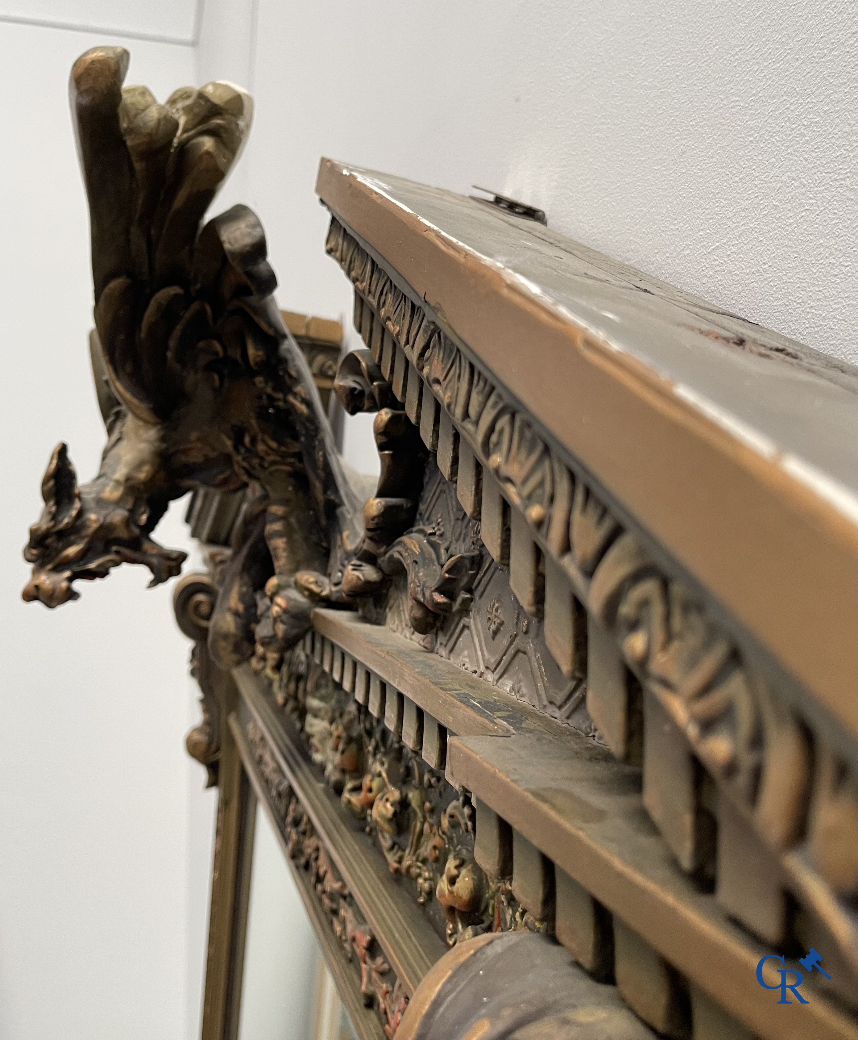 A large patinated fireplace mirror with a dragon. Around 1900.